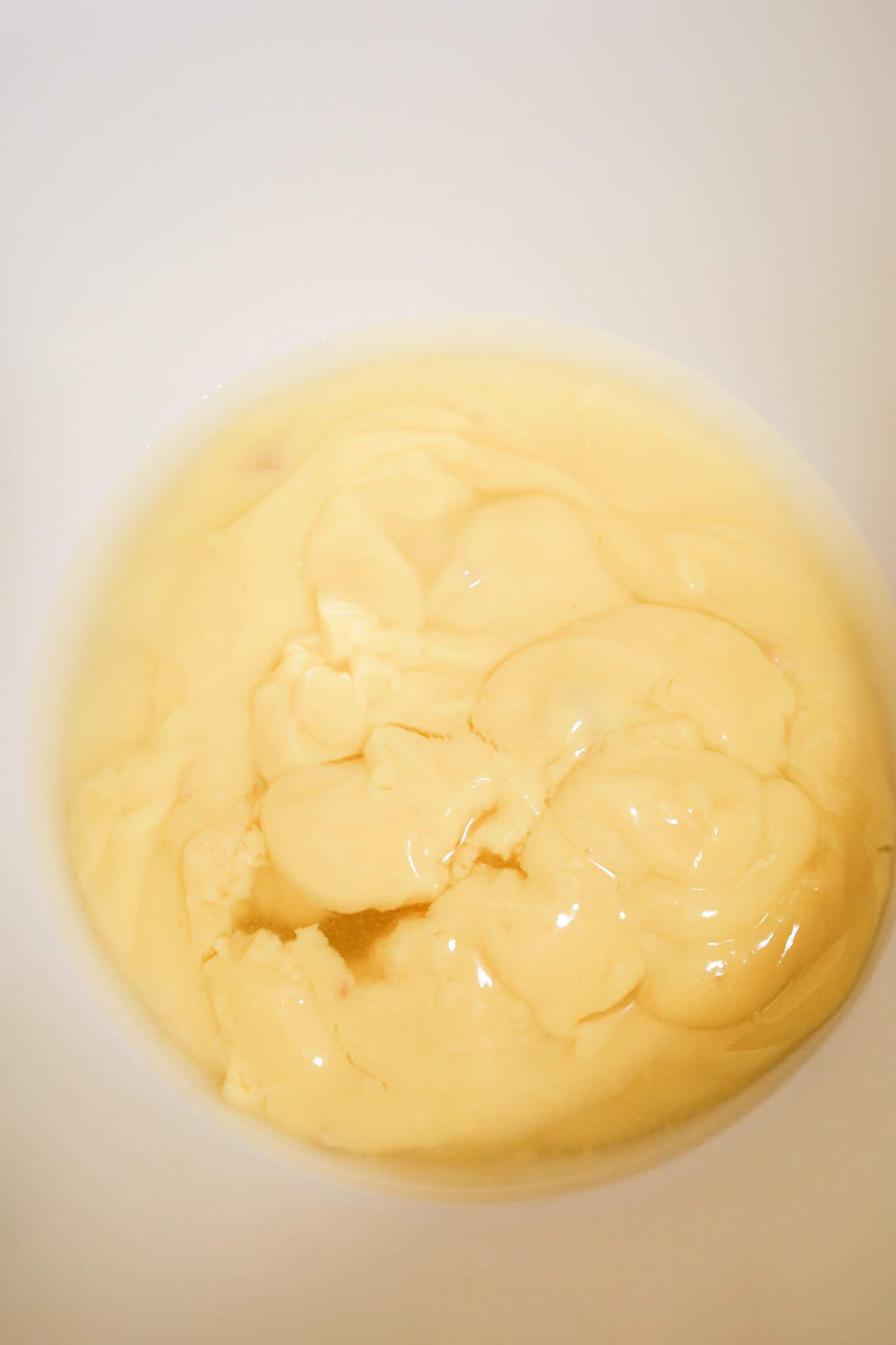 water and condensed cream of chicken soup in a mixing bowl