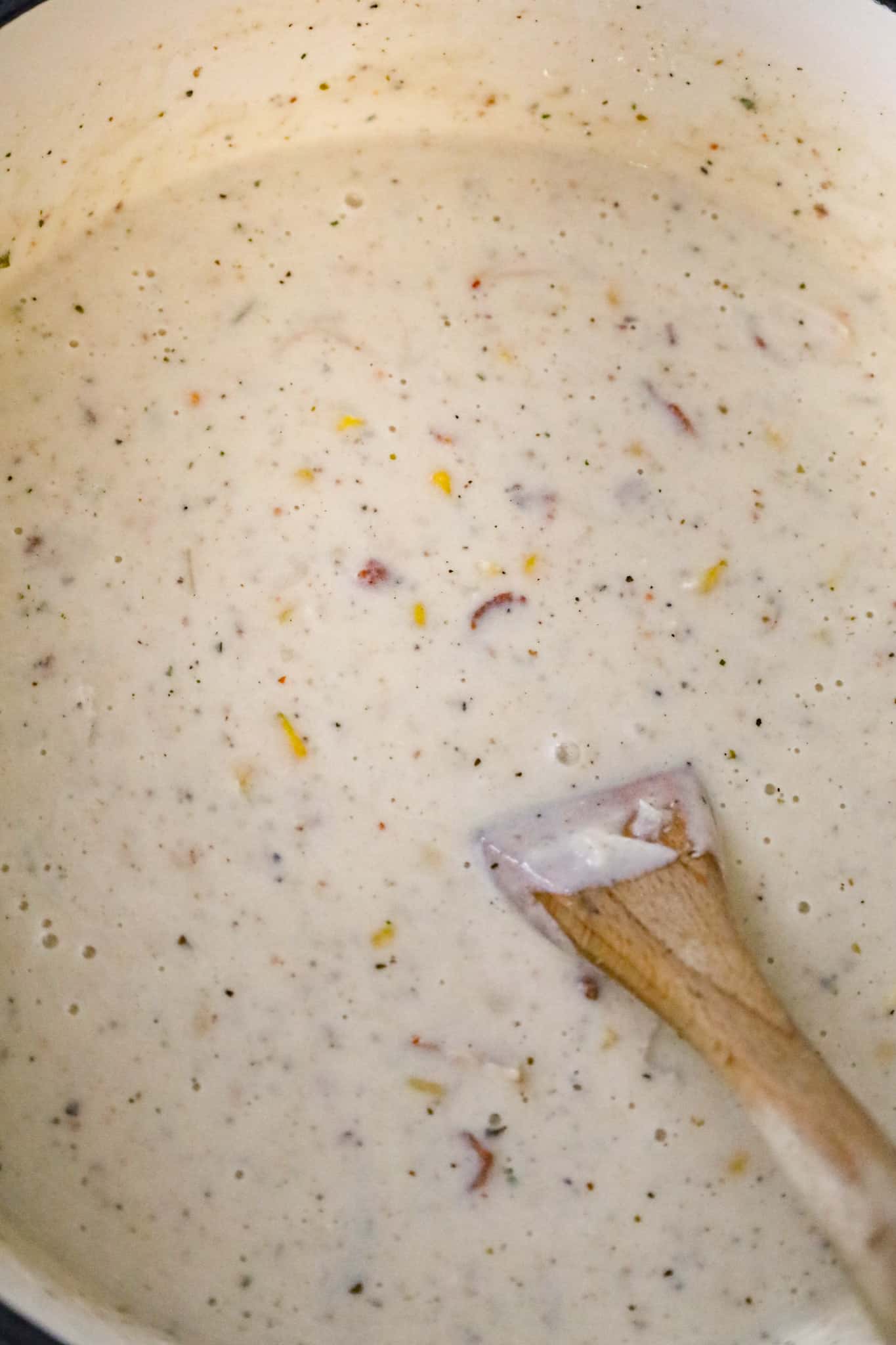 stirring turkey corn chowder in a pot