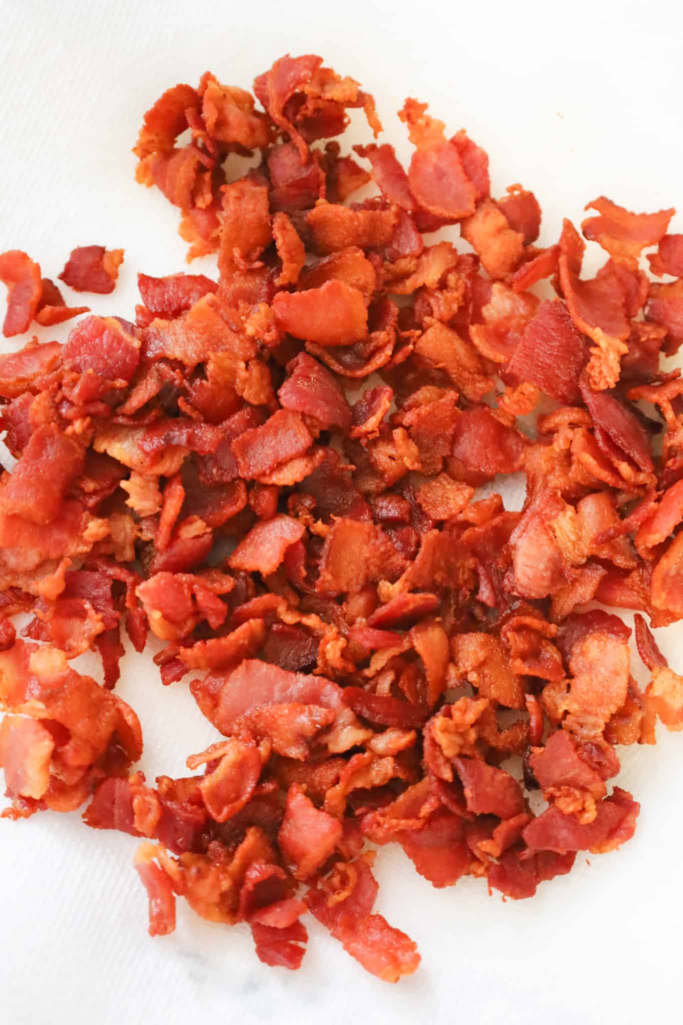 cooked chopped bacon on paper towel lined plate