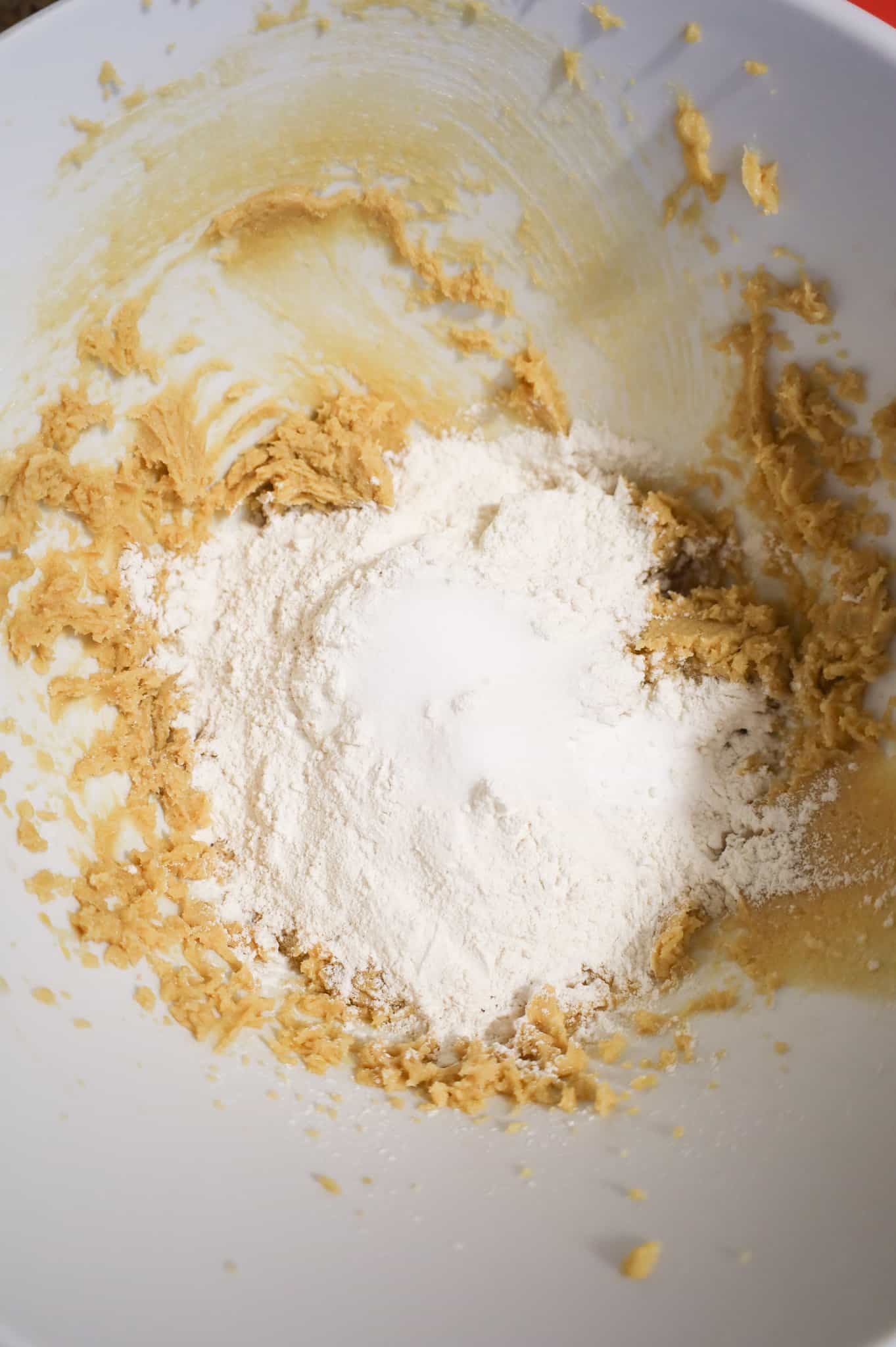 flour, salt and baking soda on top of creamed butter and sugar mixture in a mixing bowl