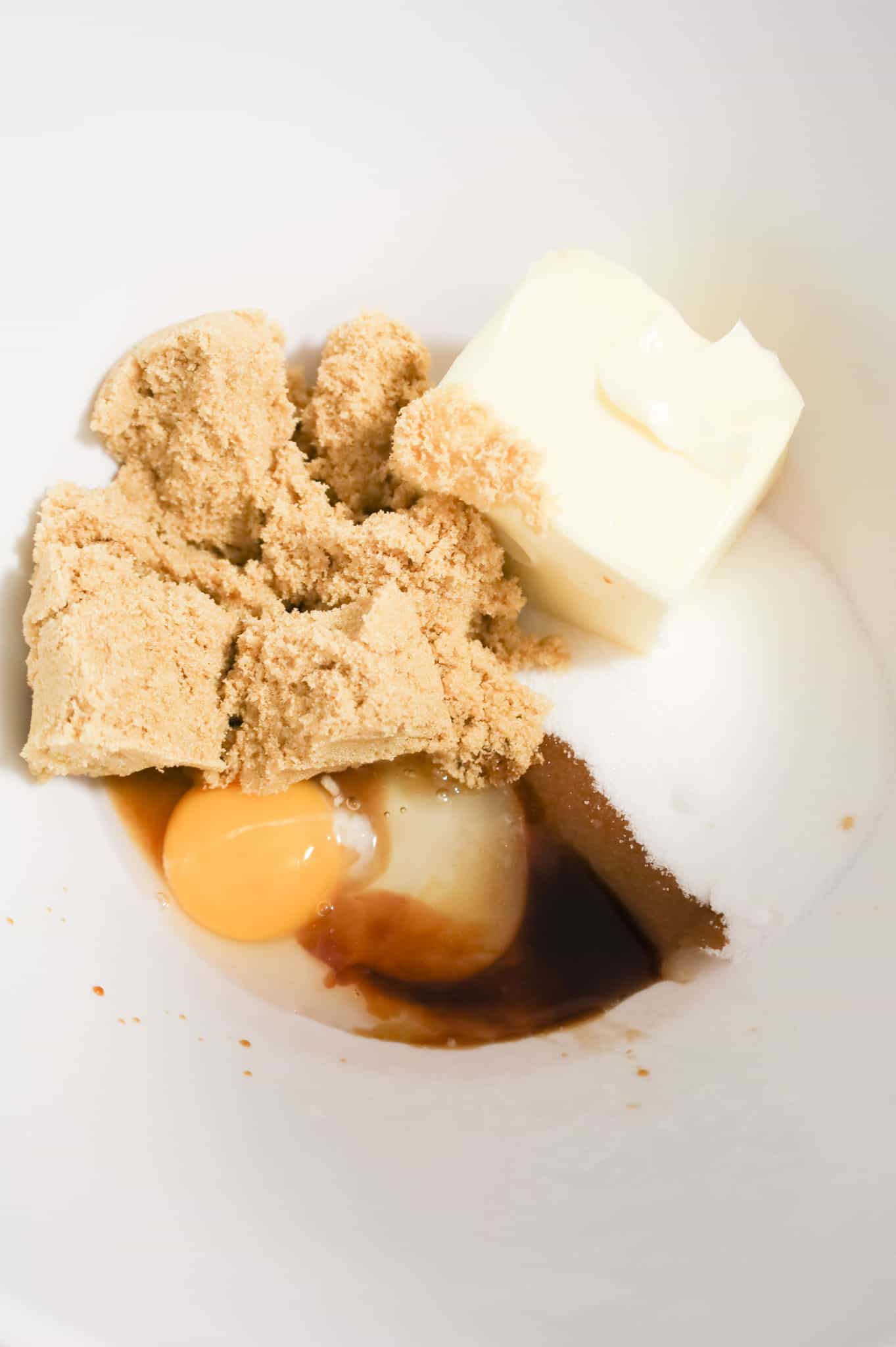 brown sugar, butter, granulated sugar, vanilla extract and an egg in a mixing bowl