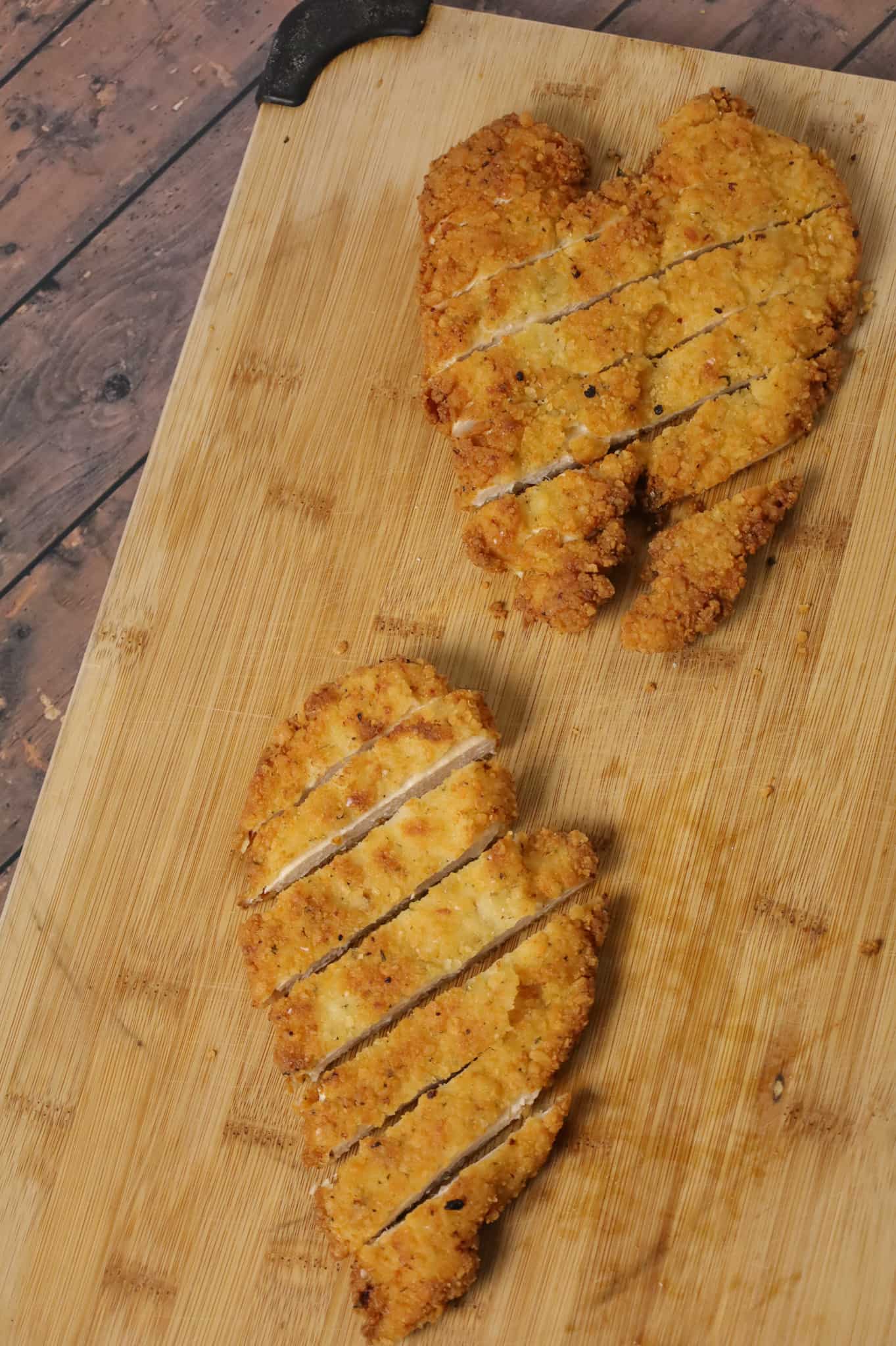 sliced breaded chicken breasts on a cutting board