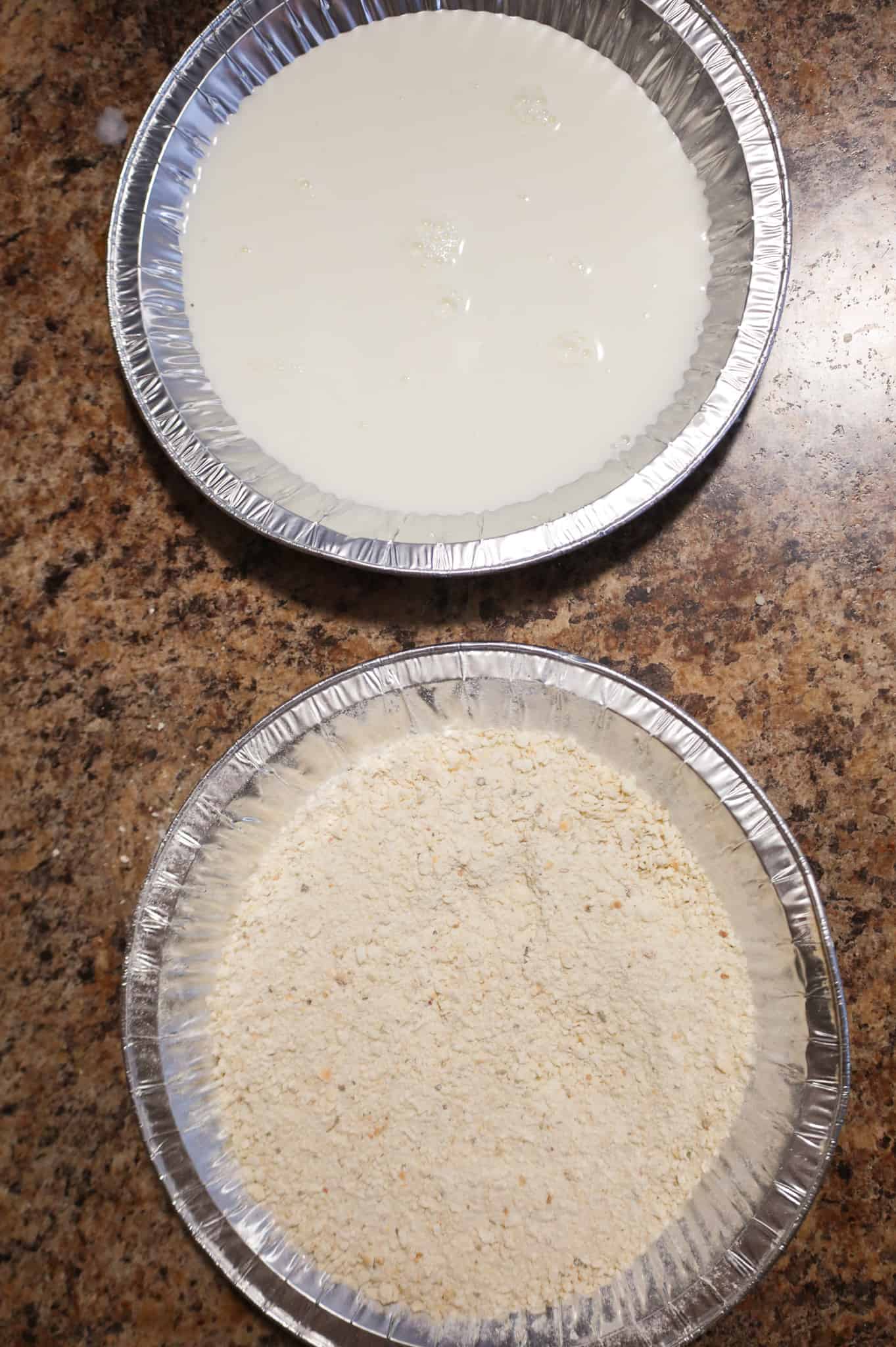 milk in one pie plate and bread crumb mixture in another pie plate