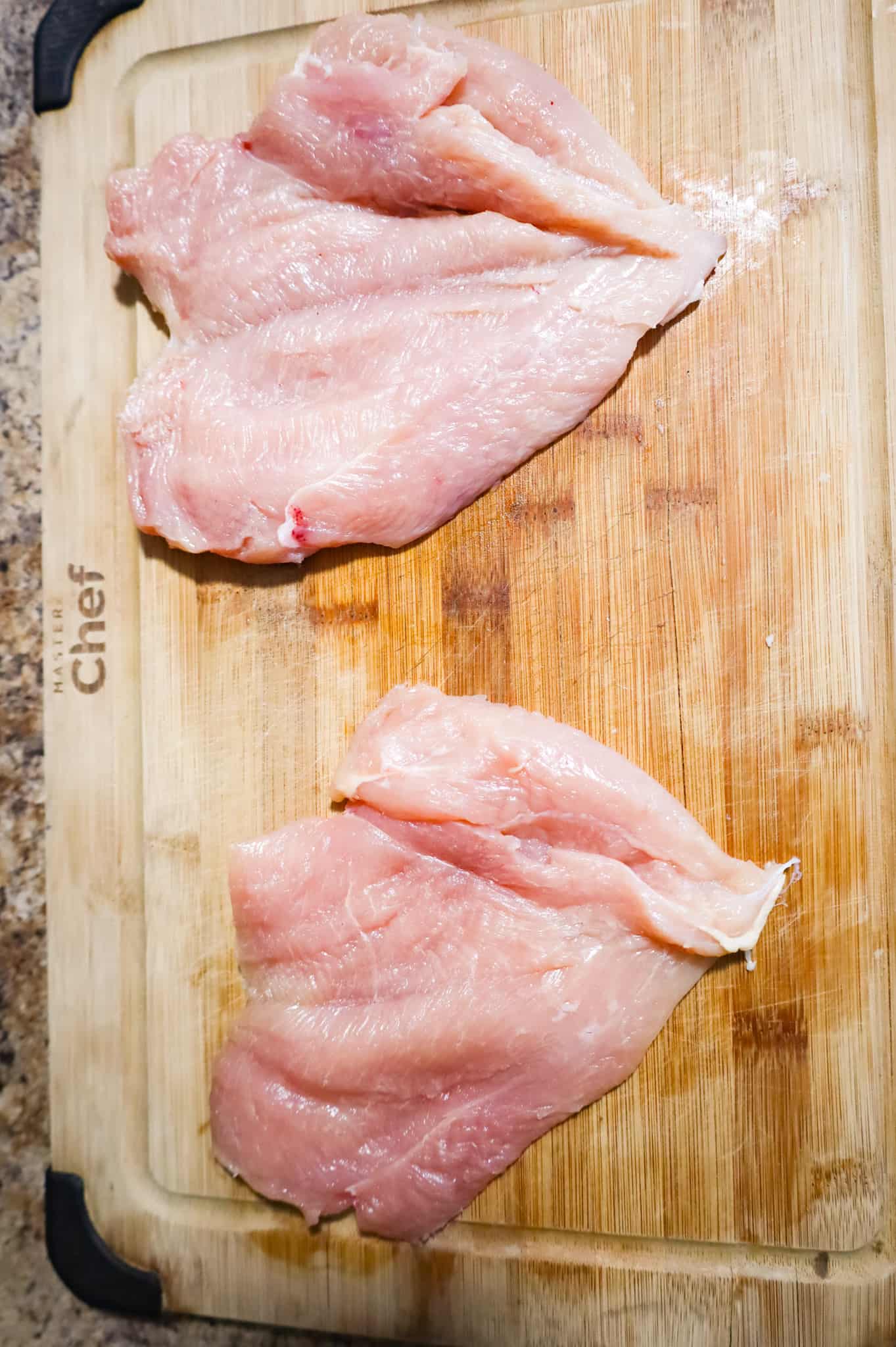 butterflied chicken breasts on a cutting board