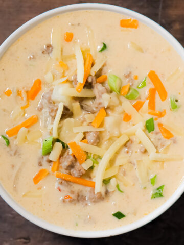 Crock Pot Cheeseburger Soup is a hearty slow cooker soup recipe loaded with ground beef, diced hash brown potatoes, chopped green onions, mozzarella and cheddar cheese.