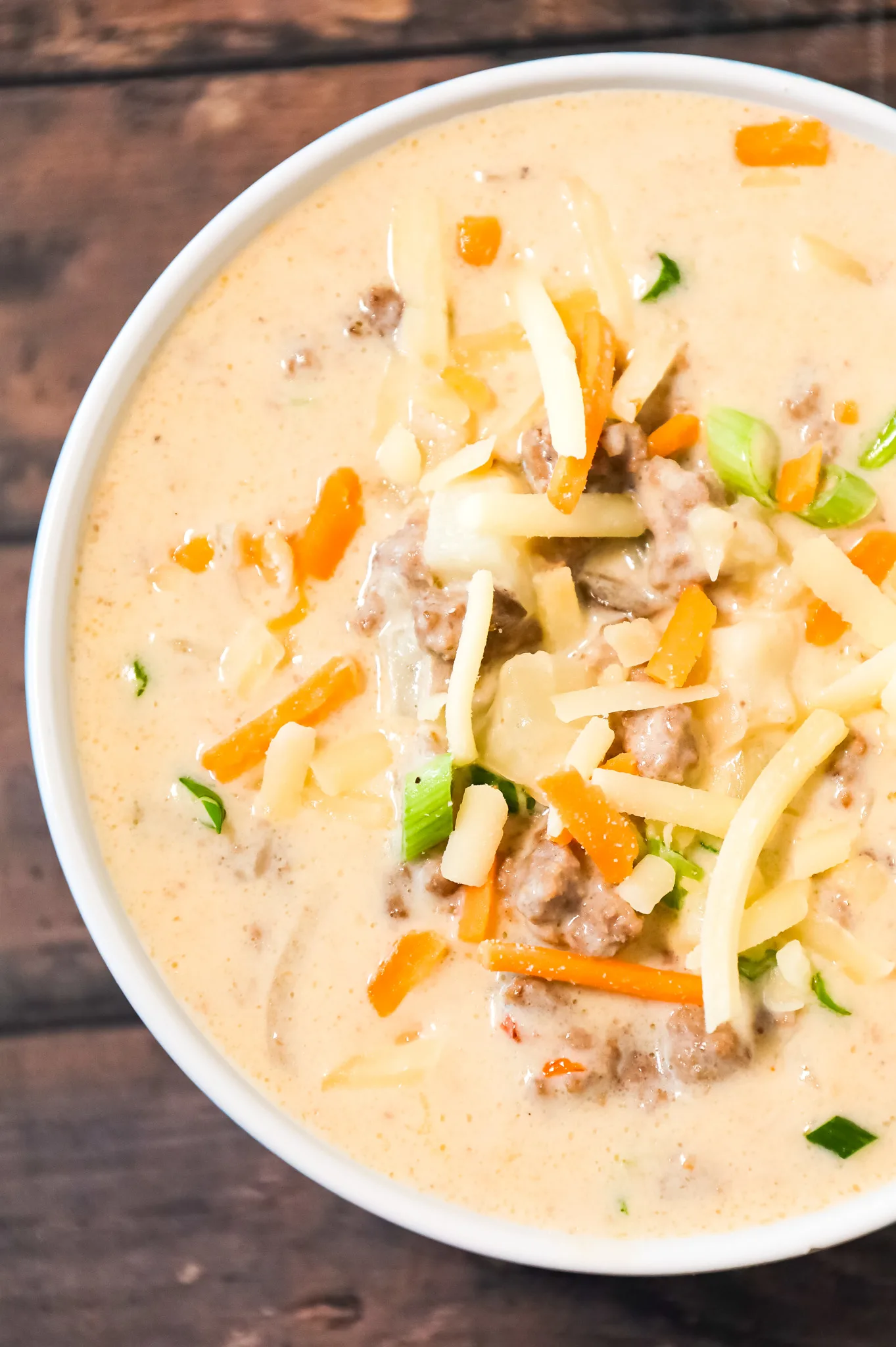 Crock Pot Cheeseburger Soup is a hearty slow cooker soup recipe loaded with ground beef, diced hash brown potatoes, chopped green onions, mozzarella and cheddar cheese.