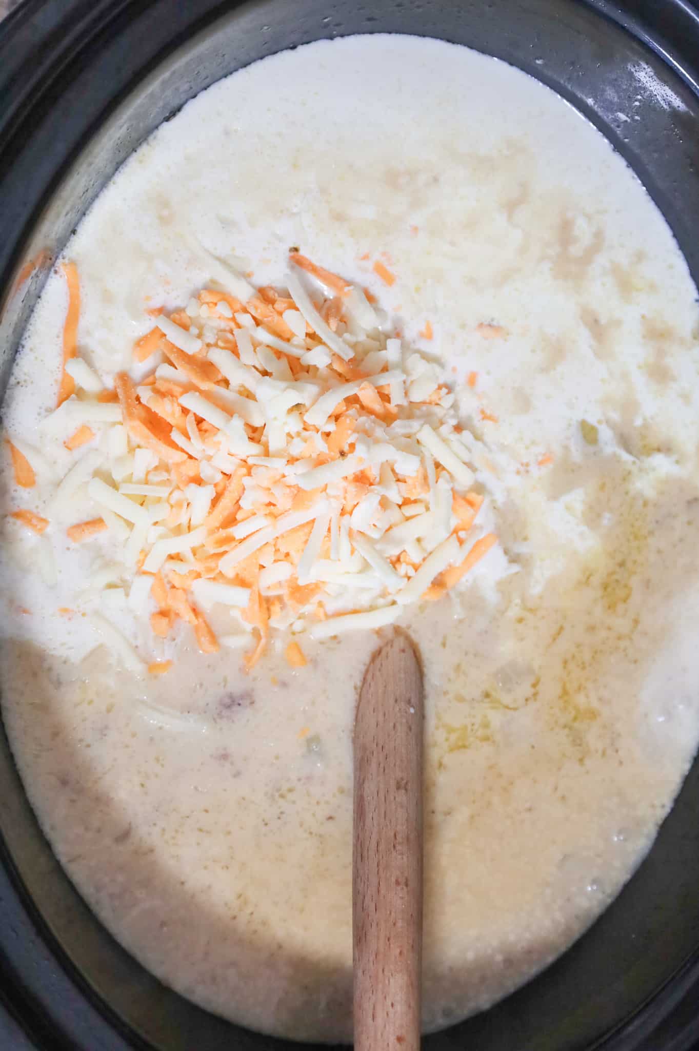 shredded cheese and heavy cream added to cheeseburger soup in a crock pot