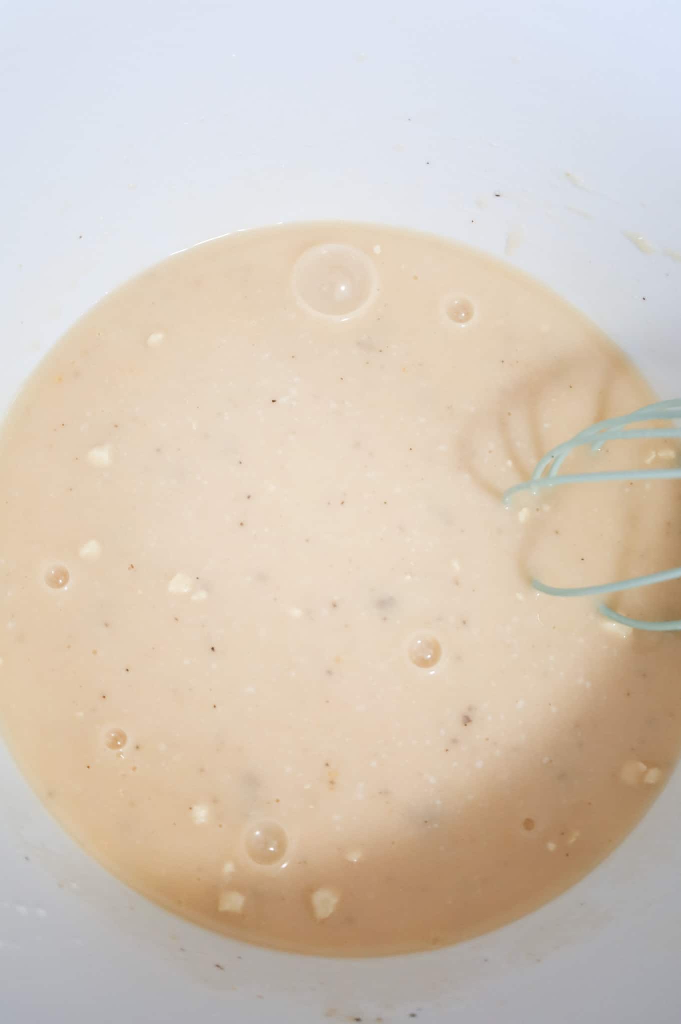 chicken broth and cream soup whisked together in a mixing bowl