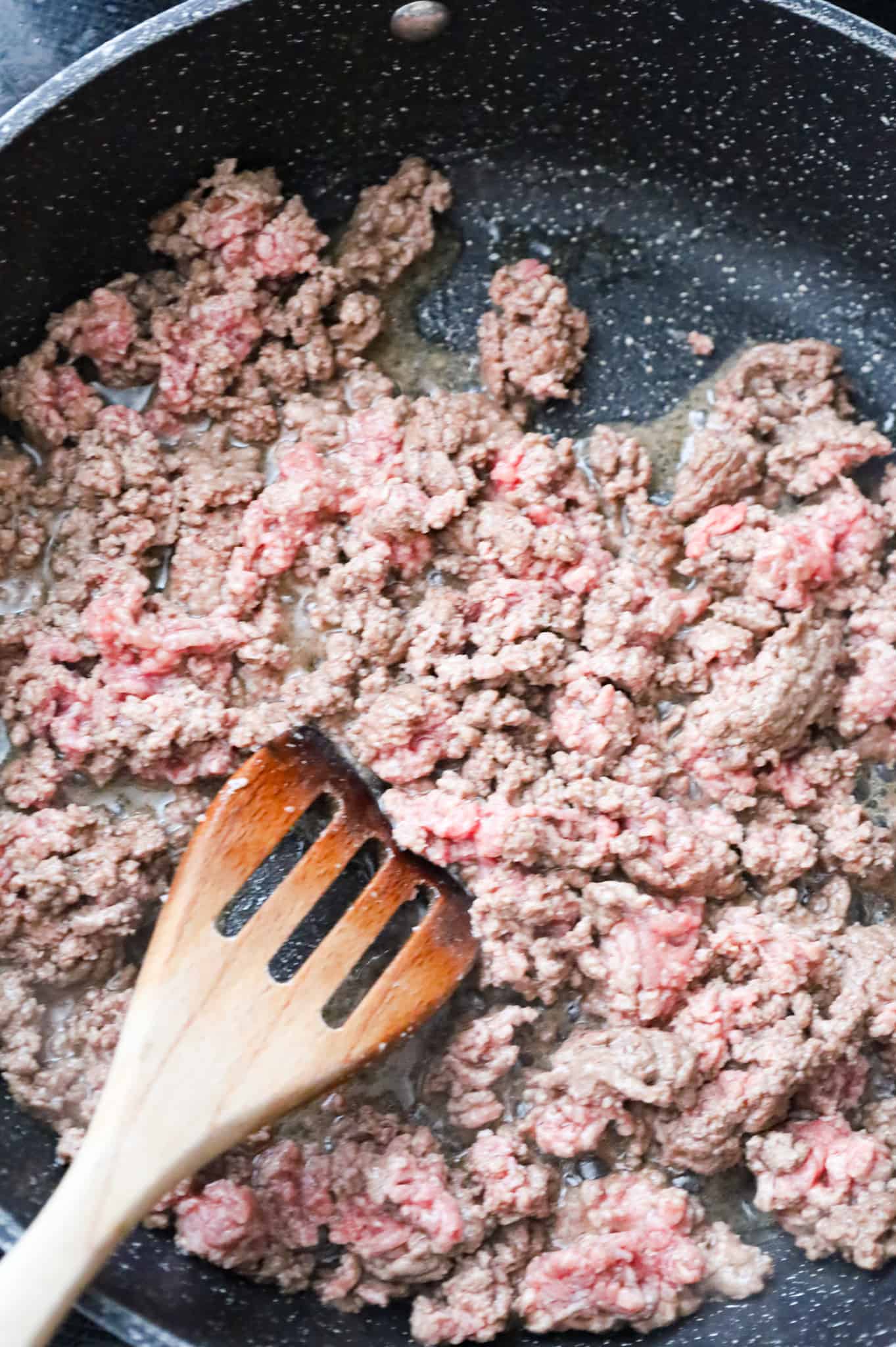 ground beef cooking in a large skillet