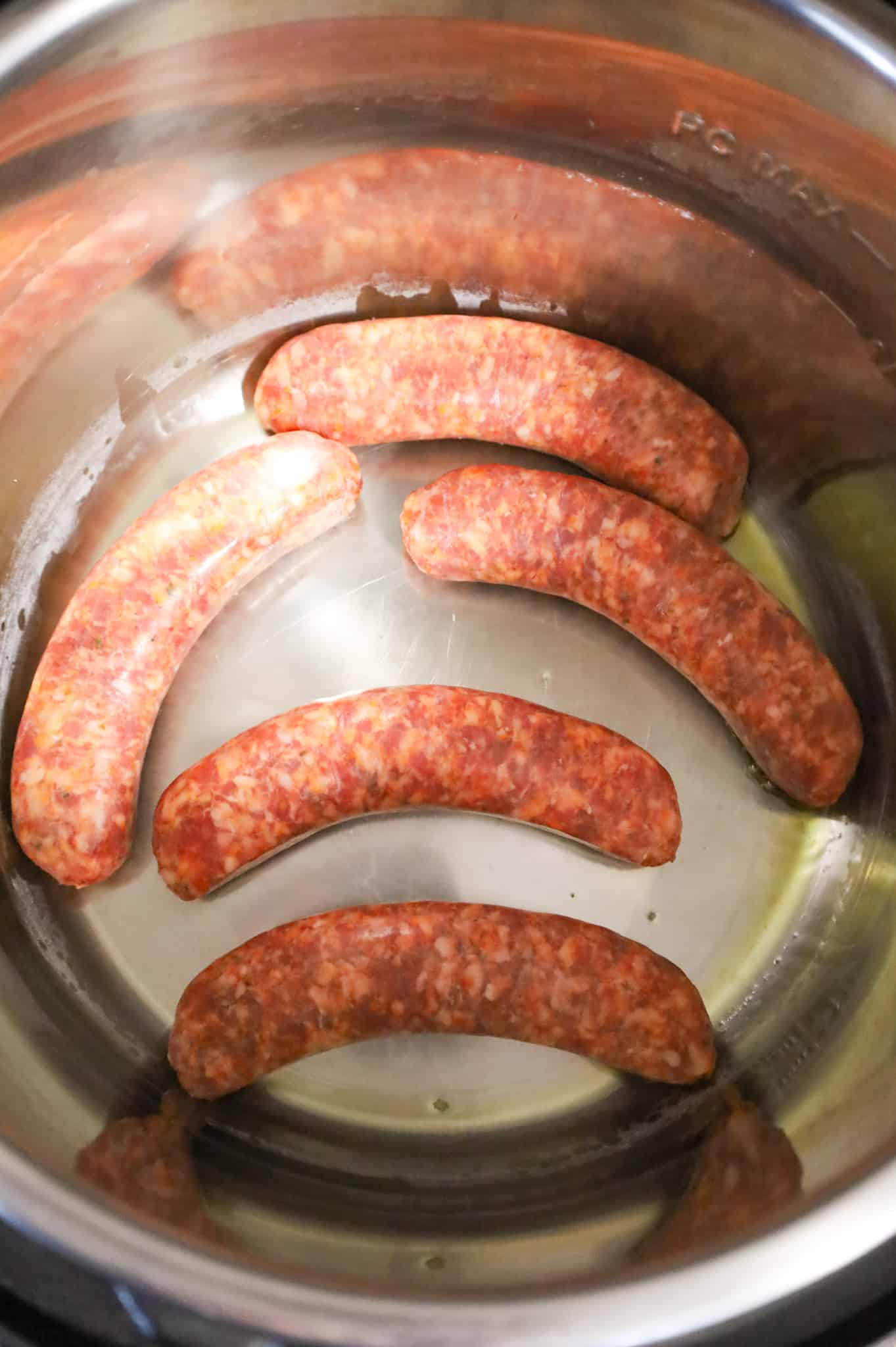 raw Italian sausages placed in an Instant Pot