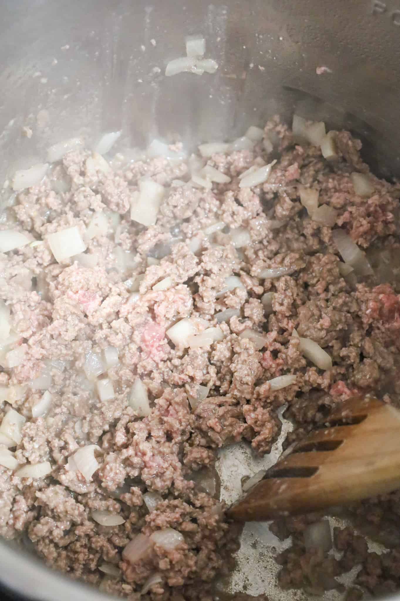 ground beef and diced onions frying in an Instant Pot