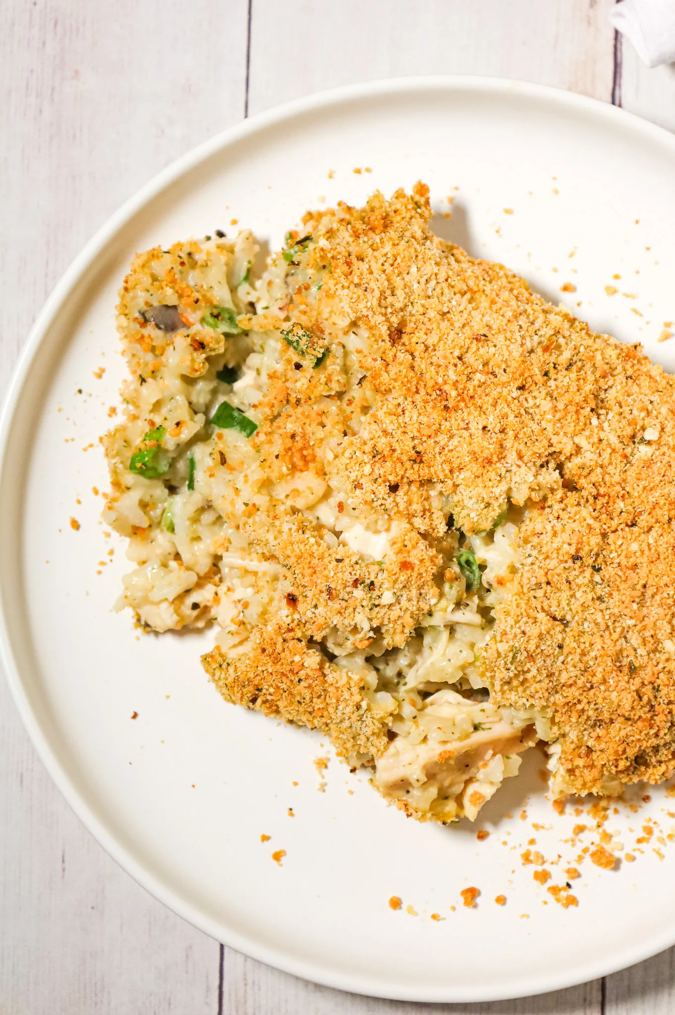 Old School Chicken and Rice Casserole is an easy dinner recipe using shredded rotisserie chicken, three flavours of cream soups, instant rice, green onions, parmesan cheese and bread crumbs.