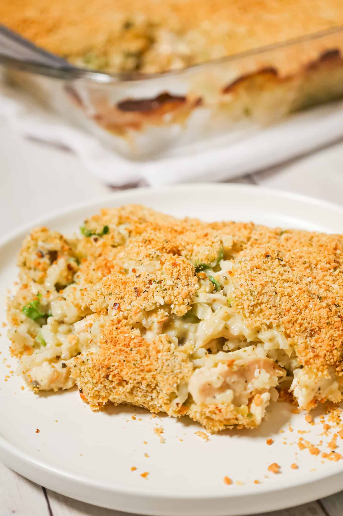 Old School Chicken and Rice Casserole is an easy dinner recipe using shredded rotisserie chicken, three flavours of cream soups, instant rice, green onions, parmesan cheese and bread crumbs.