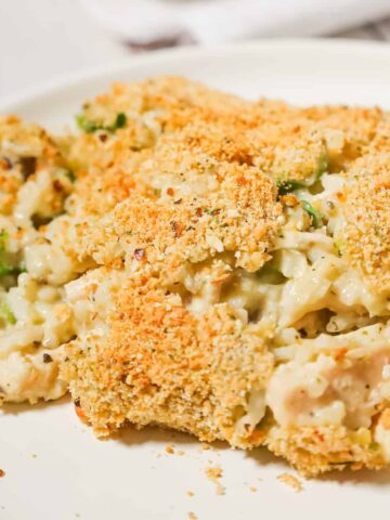 Old School Chicken and Rice Casserole is an easy dinner recipe using shredded rotisserie chicken, three flavours of cream soups, instant rice, green onions, parmesan cheese and bread crumbs.