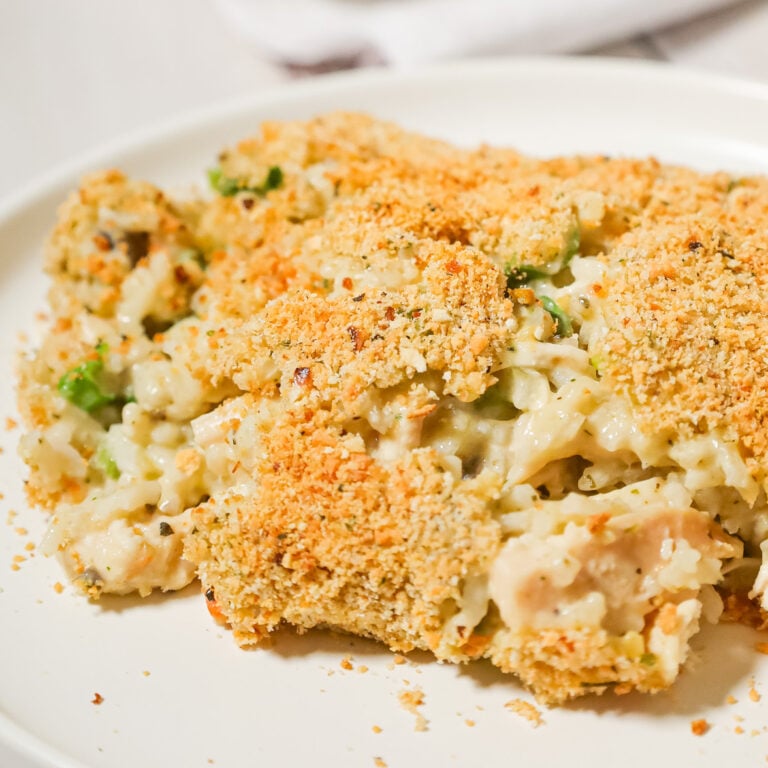 Old School Chicken and Rice Casserole is an easy dinner recipe using shredded rotisserie chicken, three flavours of cream soups, instant rice, green onions, parmesan cheese and bread crumbs.