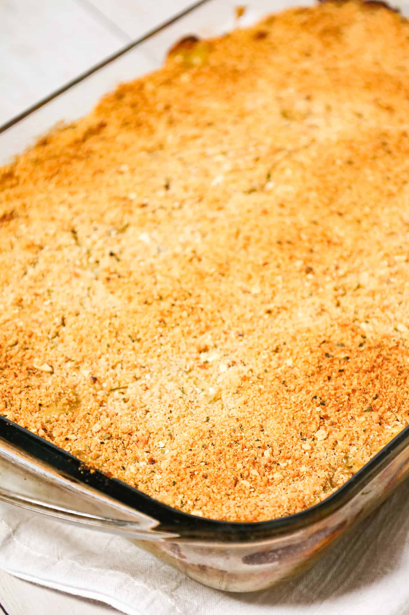 Old School Chicken and Rice Casserole is an easy dinner recipe using shredded rotisserie chicken, three flavours of cream soups, instant rice, green onions, parmesan cheese and bread crumbs.
