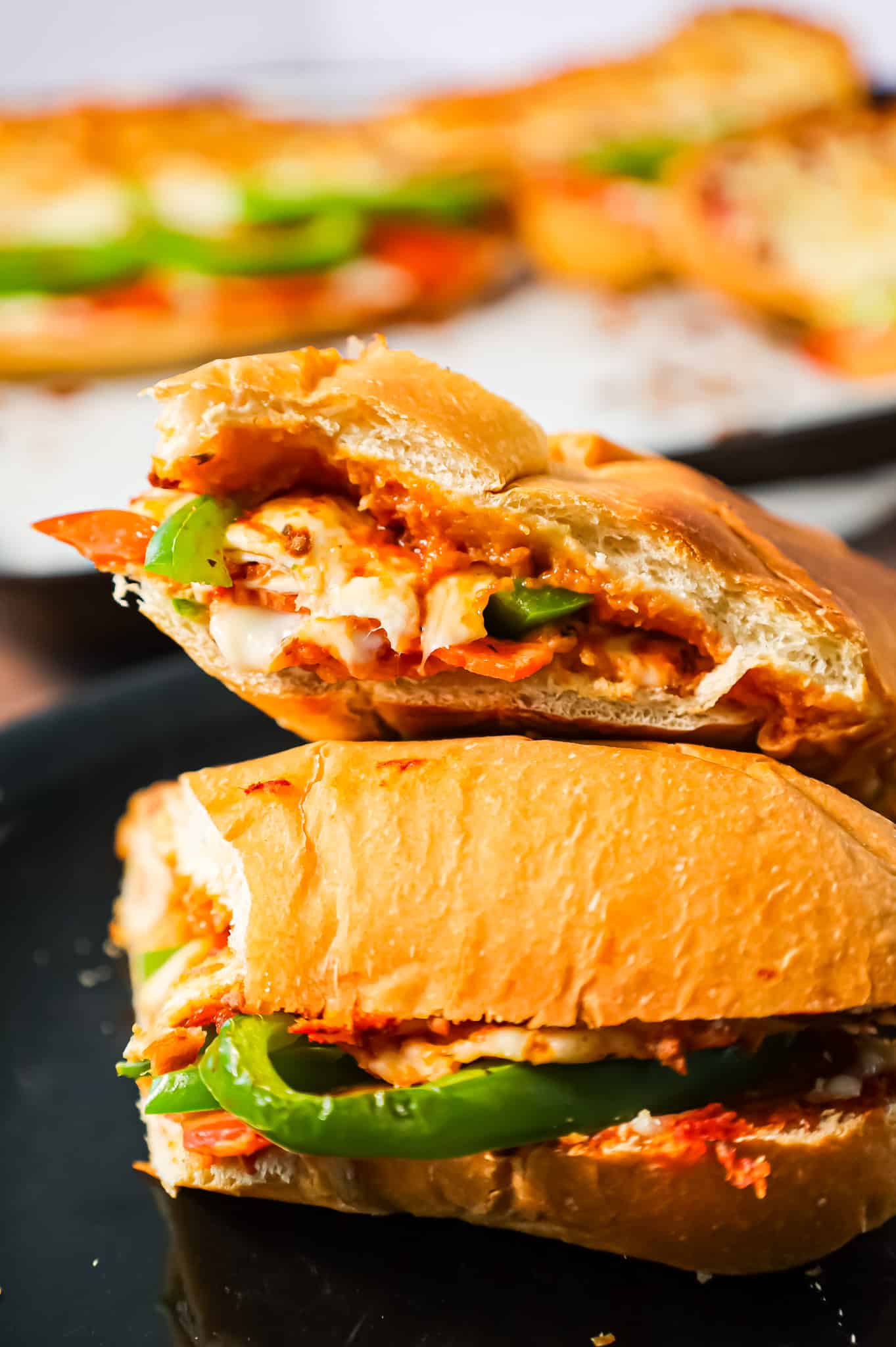 Pizza Subs are an easy weeknight dinner recipe using 9 inch sub rolls loaded with pizza sauce, mozzarella cheese, pepperoni and green peppers and then baked until perfectly toasted.