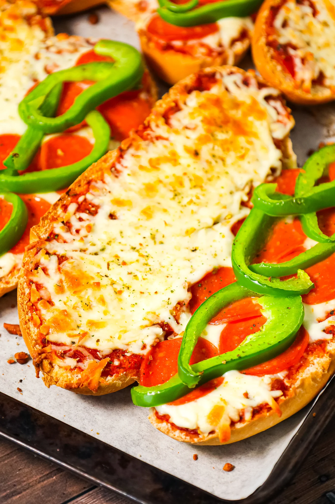 Pizza Subs are an easy weeknight dinner recipe using 9 inch sub rolls loaded with pizza sauce, mozzarella cheese, pepperoni and green peppers and then baked until perfectly toasted.