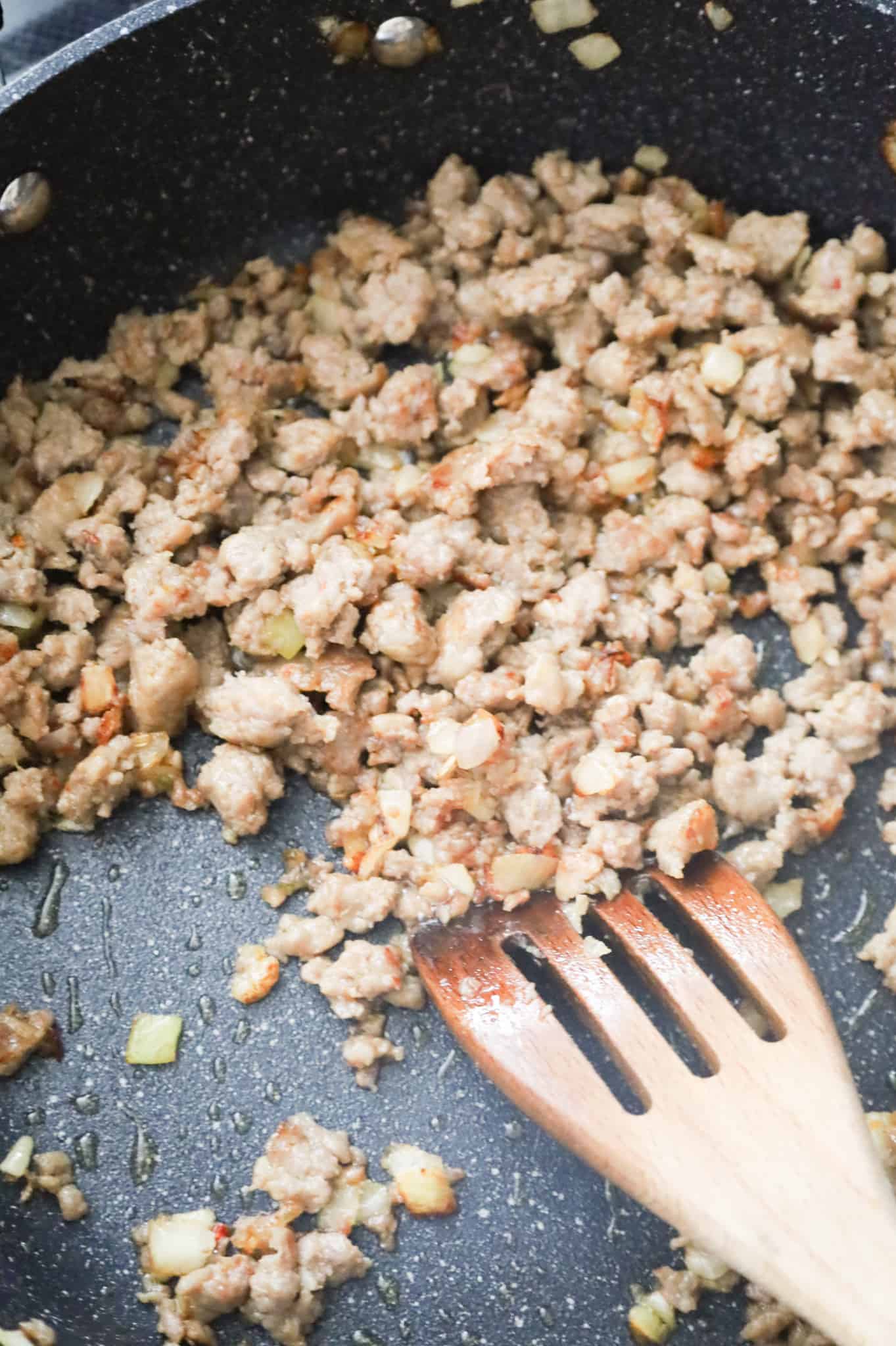 browned sausage and diced onions in a skillet