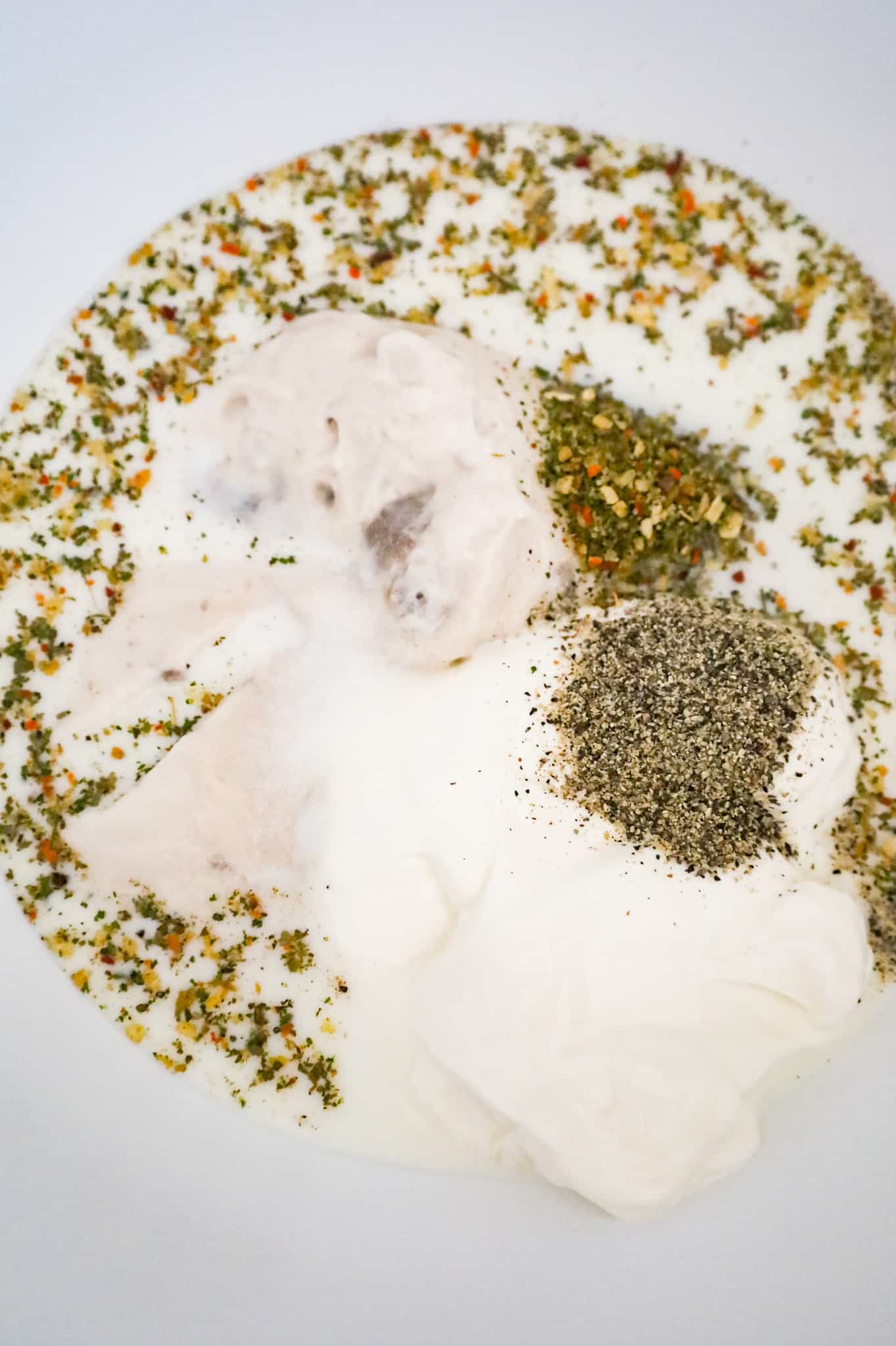 Italian seasoning, salt, pepper, sour cream, milk and cream of mushroom soup in a mixing bowl