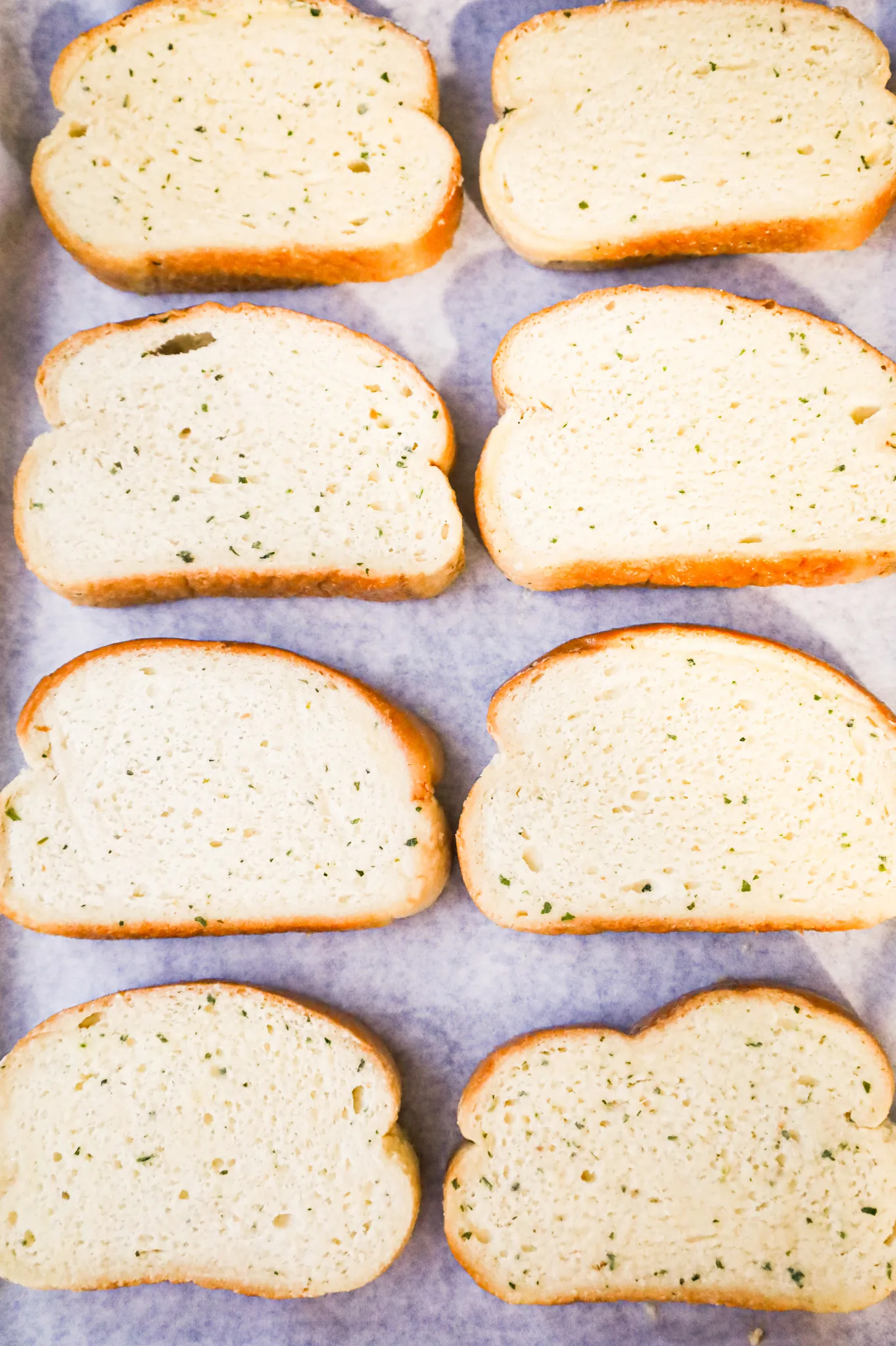 slices of garlic toast on a parchment lined baking sheet