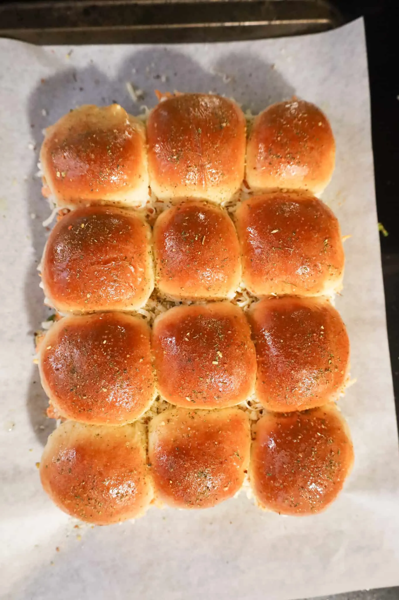 dinner rolls brushed with butter and sprinkled with Italian seasoning