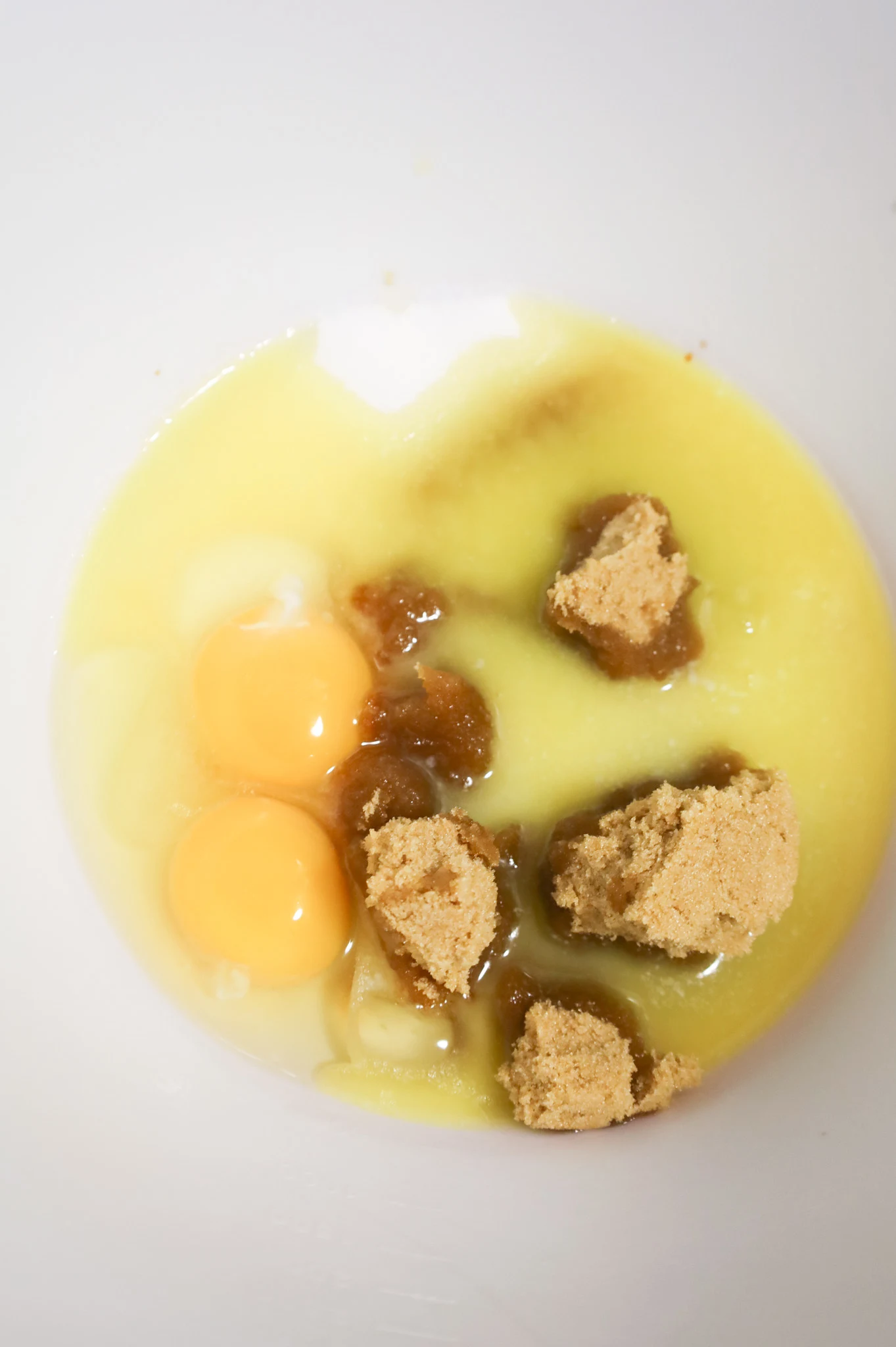 melted butter, eggs, vanilla extract, brown sugar and granulated sugar in a mixing bowl