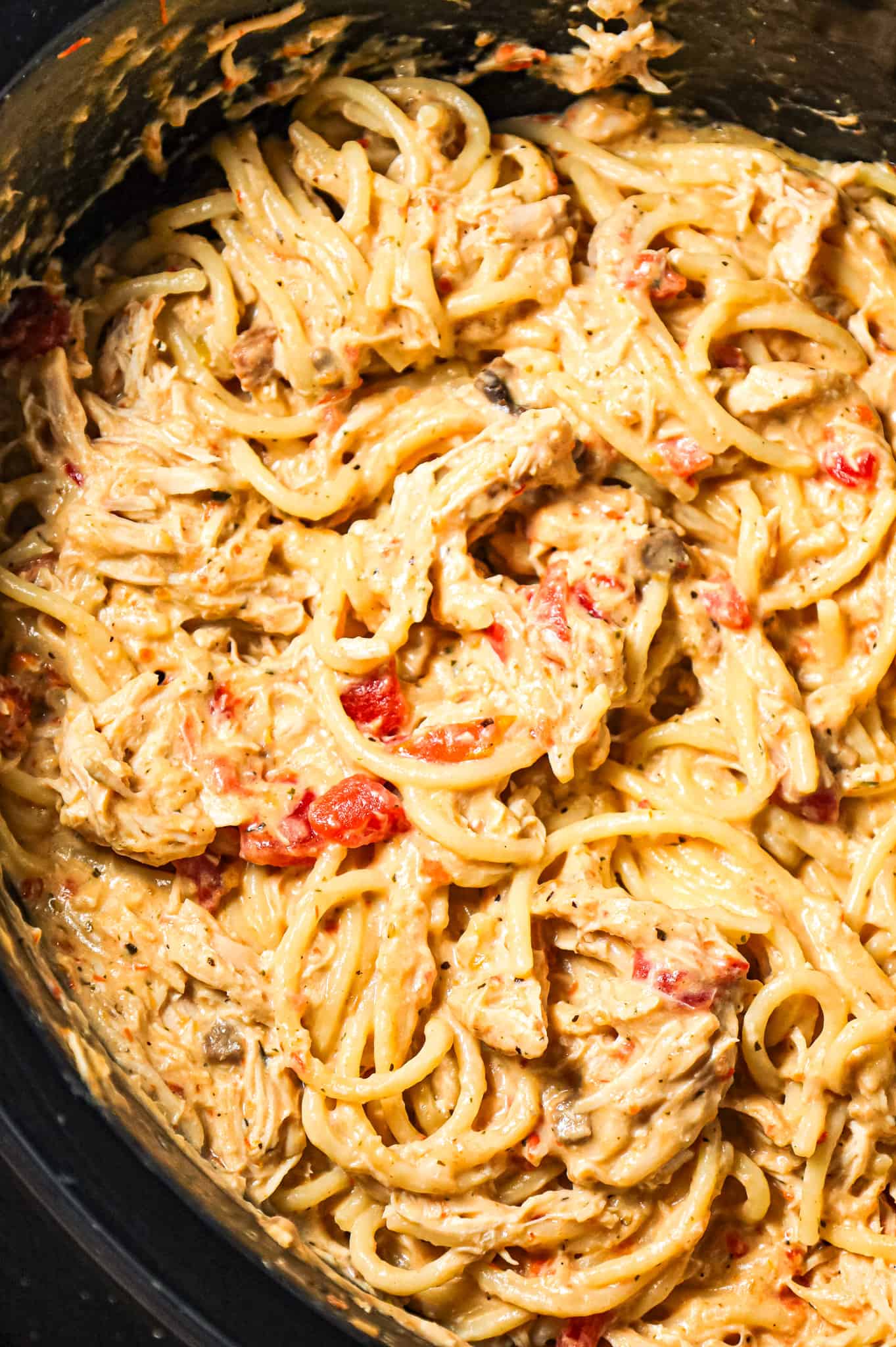 Crock Pot Chicken Spaghetti is a hearty slow cooker pasta recipe made with boneless, skinless chicken breasts cooked in a cream soup and cream cheese mixture and loaded with shredded cheese.