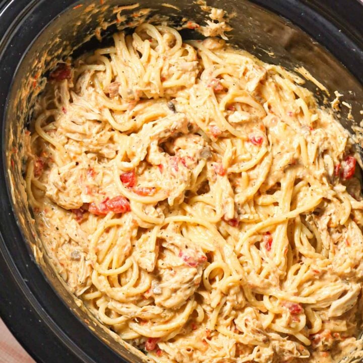 Crock Pot Chicken Spaghetti is a hearty slow cooker pasta recipe made with boneless, skinless chicken breasts cooked in a cream soup and cream cheese mixture and loaded with shredded cheese.