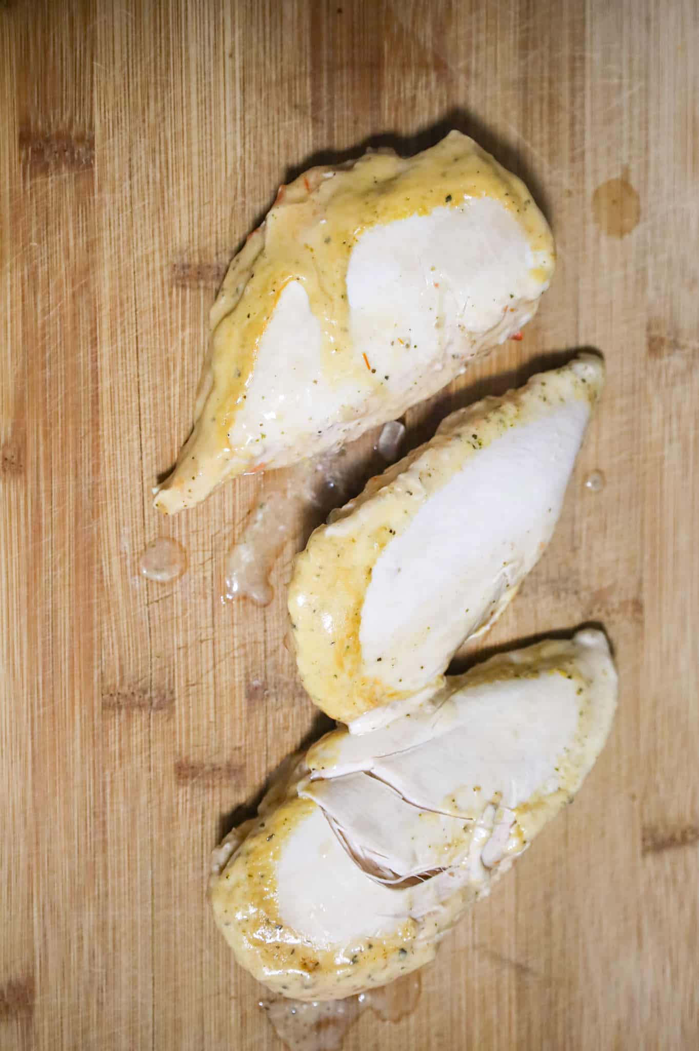 cooked chicken breasts on a cutting board