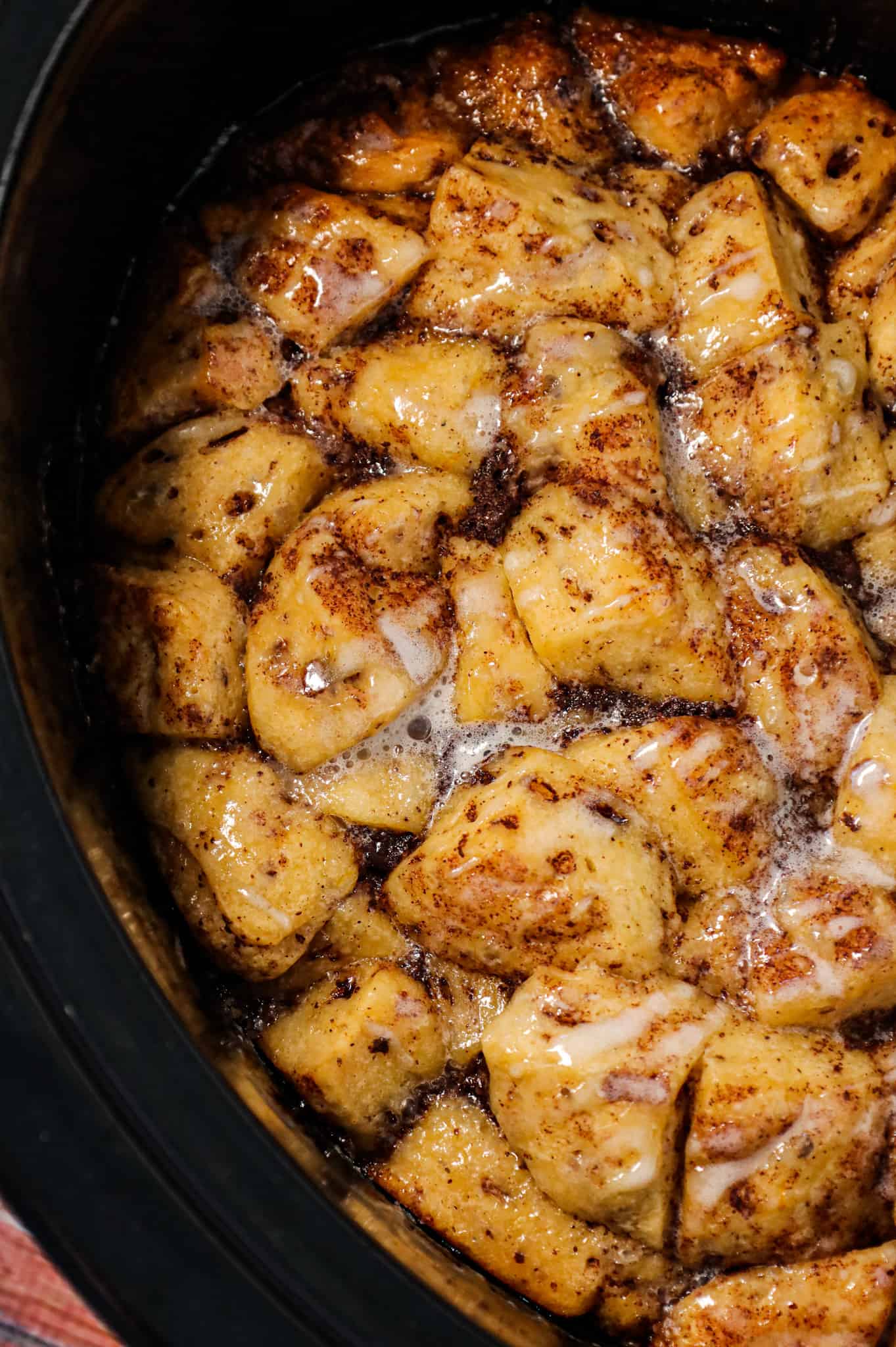 Crock Pot Cinnamon Roll Casserole is an easy slow cooker breakfast casserole recipe using Pillsbury cinnamon rolls cooked in a creamy egg mixture flavoured with maple syrup, cinnamon and orange juice.