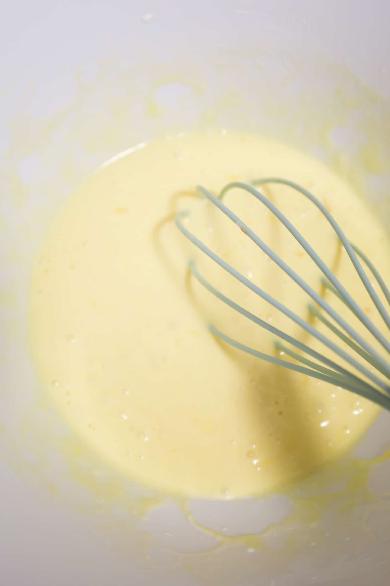 egg and cream mixture whisked in a mixing bowl