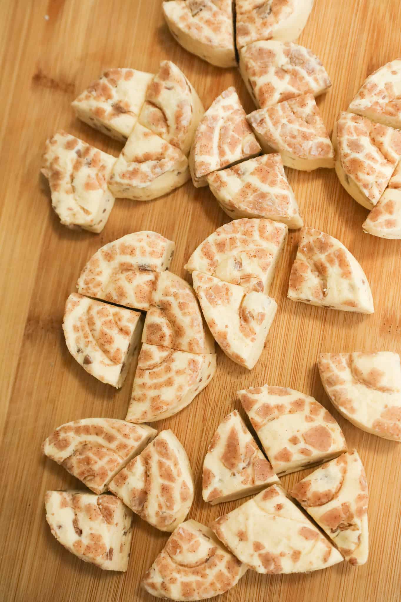 quarters of raw Pillsbury cinnamon rolls on a cutting board