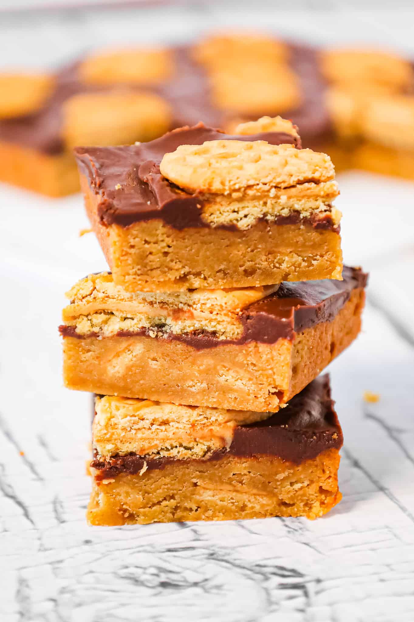 Nutter Butter Bars are a delicious dessert recipe with a layer of chewy peanut butter blondies topped with creamy chocolate and Nutter Butter cookies.