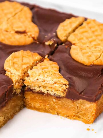Nutter Butter Bars are a delicious dessert recipe with a layer of chewy peanut butter blondies topped with creamy chocolate and Nutter Butter cookies.