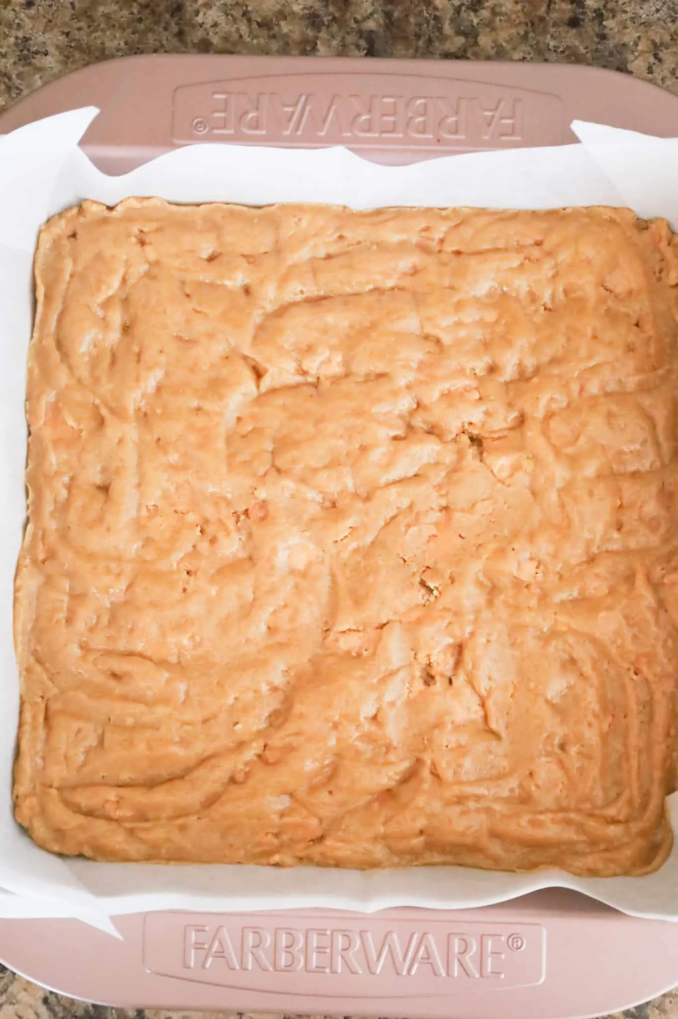 peanut butter blondie batter in a baking pan