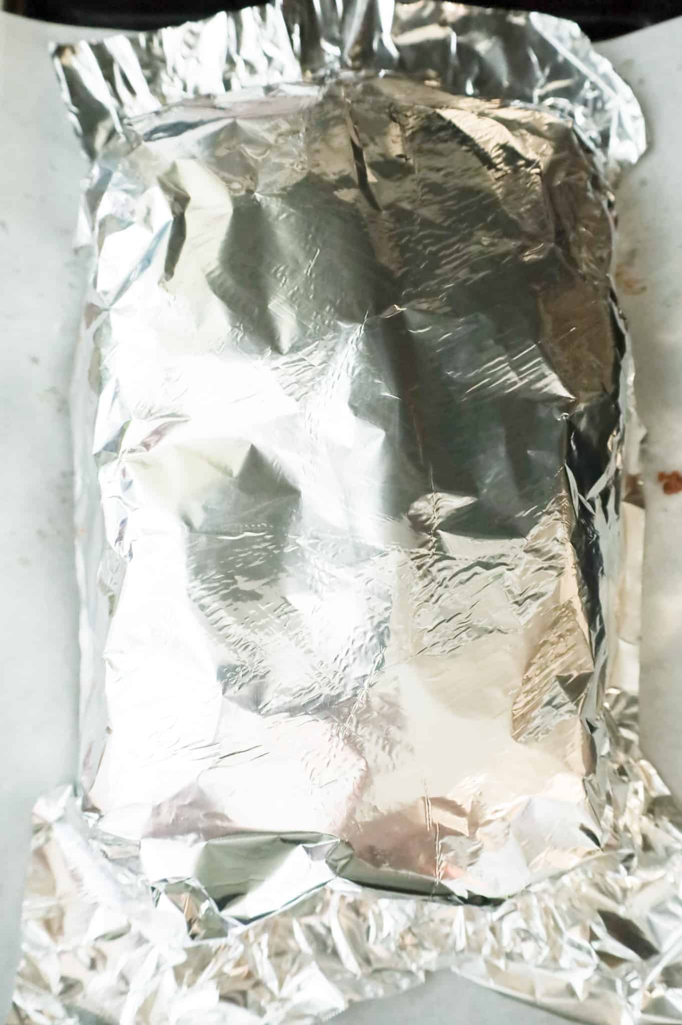 aluminum foil covering sliders on a baking sheet