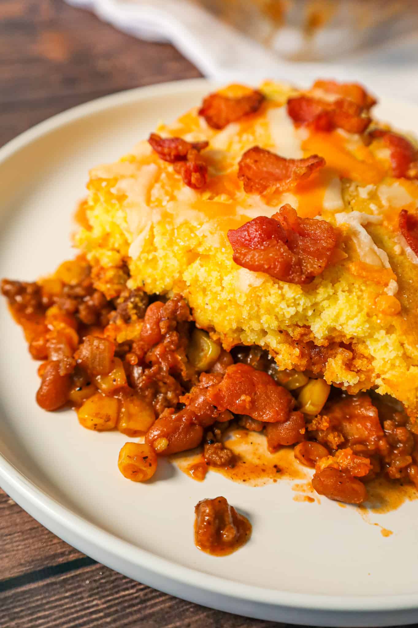 Cowboy Cornbread Casserole is an easy ground beef casserole recipe loaded with bacon, baked beans and corn with Jiffy cornbread baked on top.