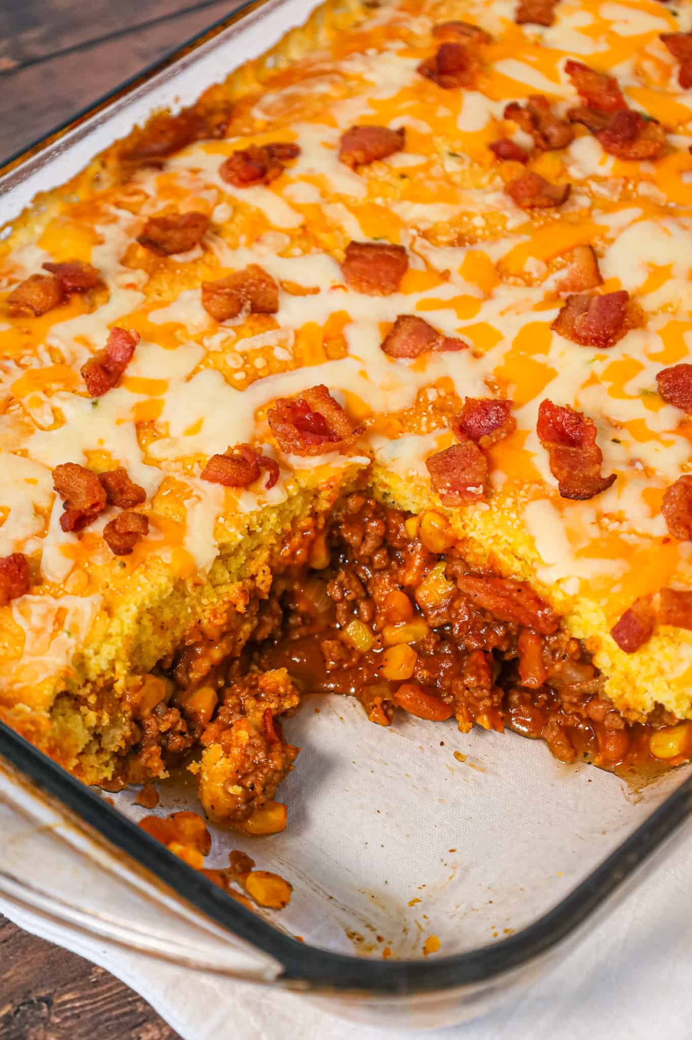 Cowboy Cornbread Casserole is an easy ground beef casserole recipe loaded with bacon, baked beans and corn with Jiffy cornbread baked on top.