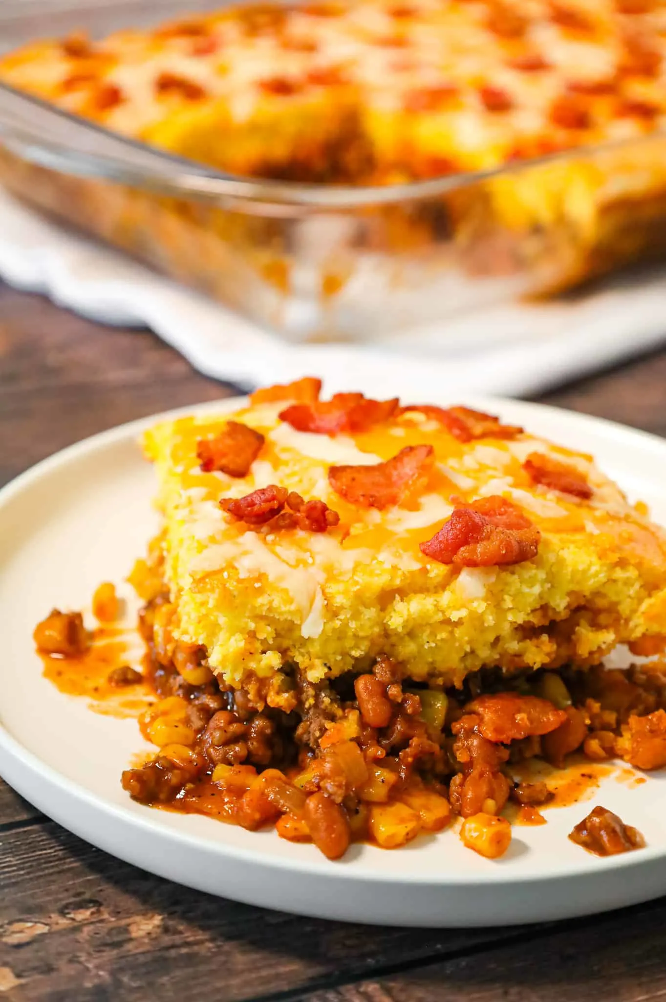 Cowboy Cornbread Casserole is an easy ground beef casserole recipe loaded with bacon, baked beans and corn with Jiffy cornbread baked on top.