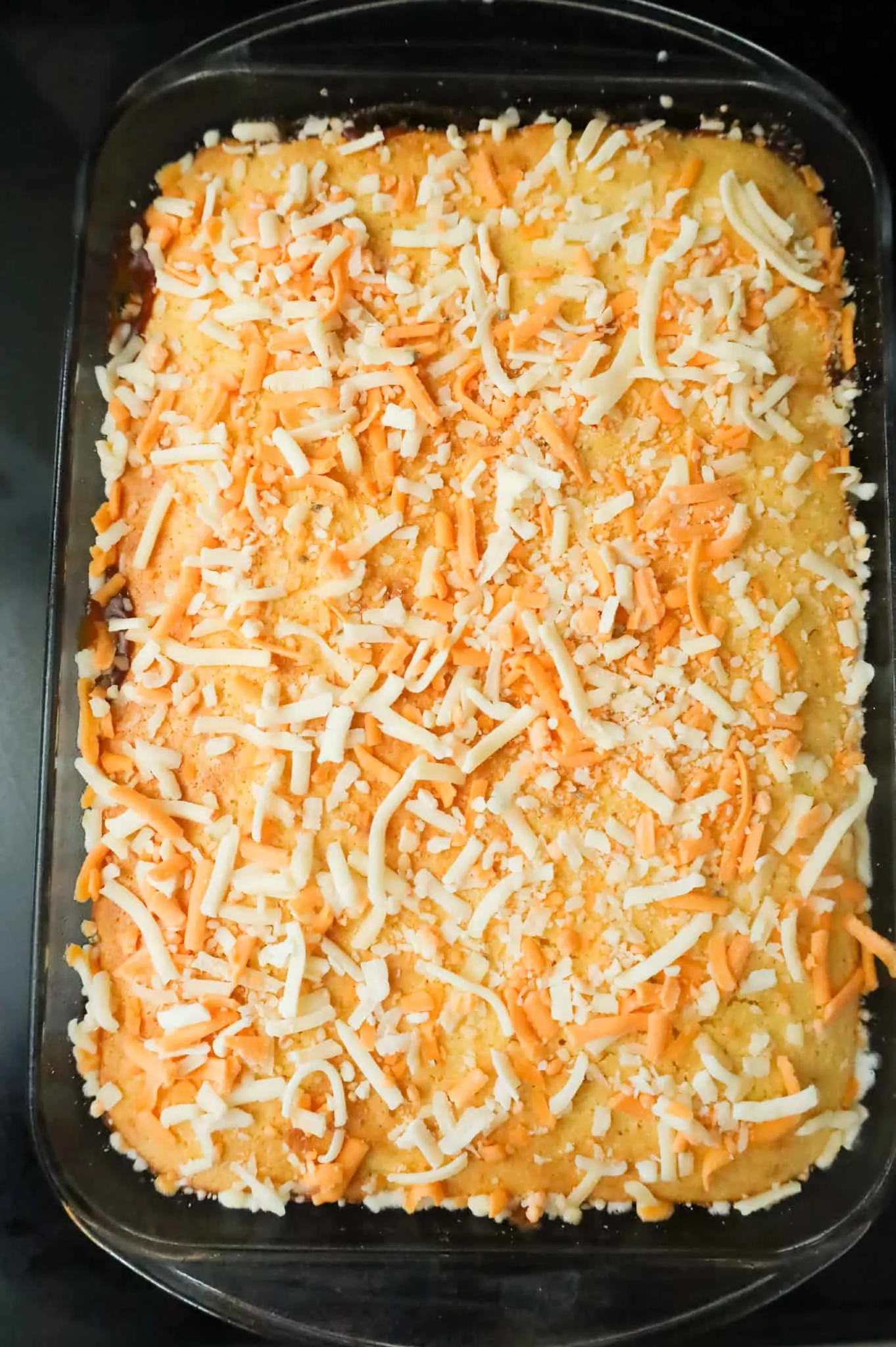 shredded cheese on top of cornbread casserole