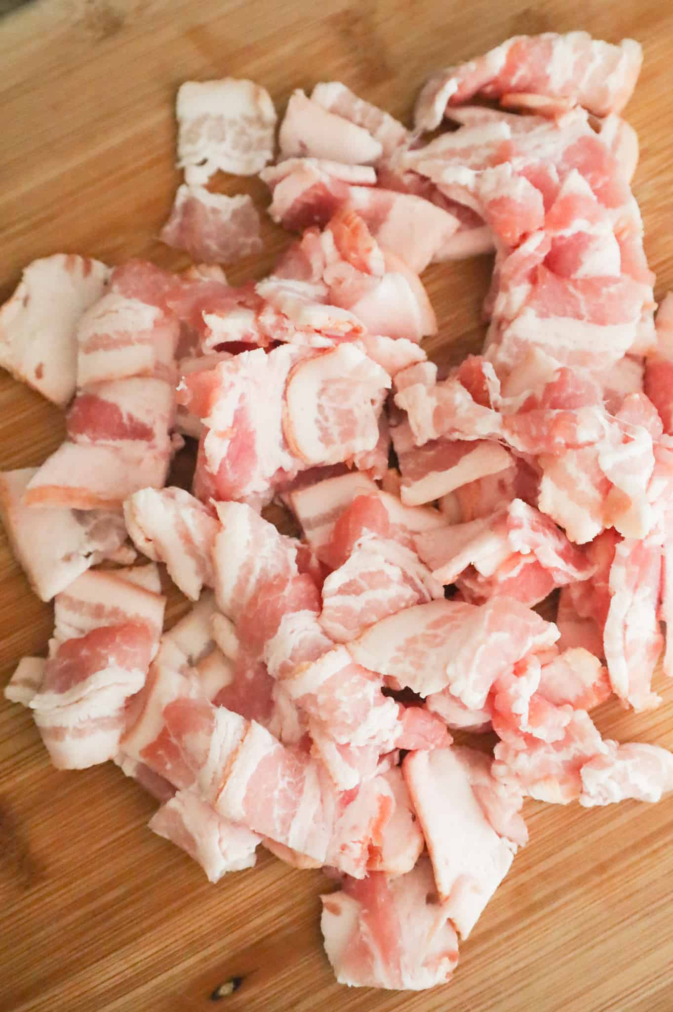 chopped raw bacon on a cutting board