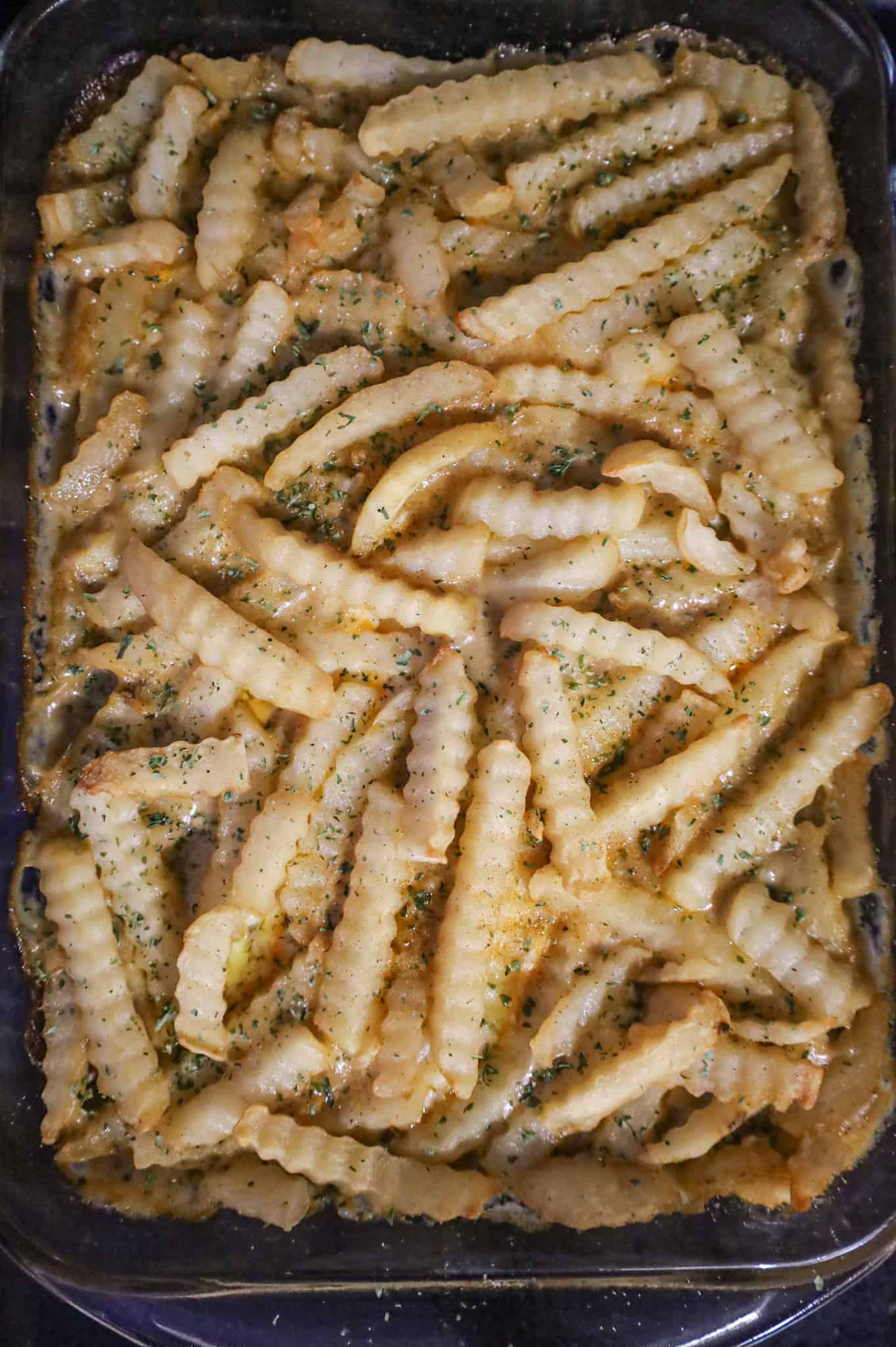 parsley and seasoned salt sprinkled on top of French fry casserole