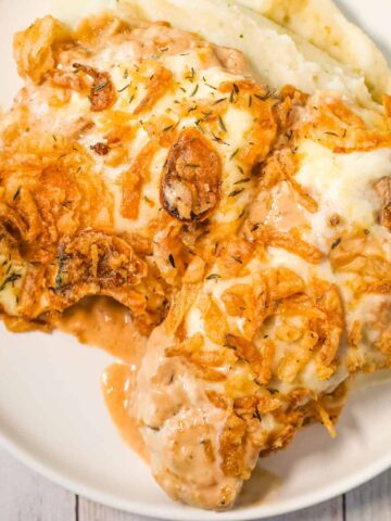 French Onion Pork Chops are an easy baked pork chop recipe loaded with sour cream, onion soup mix, provolone cheese and crispy fried onions.