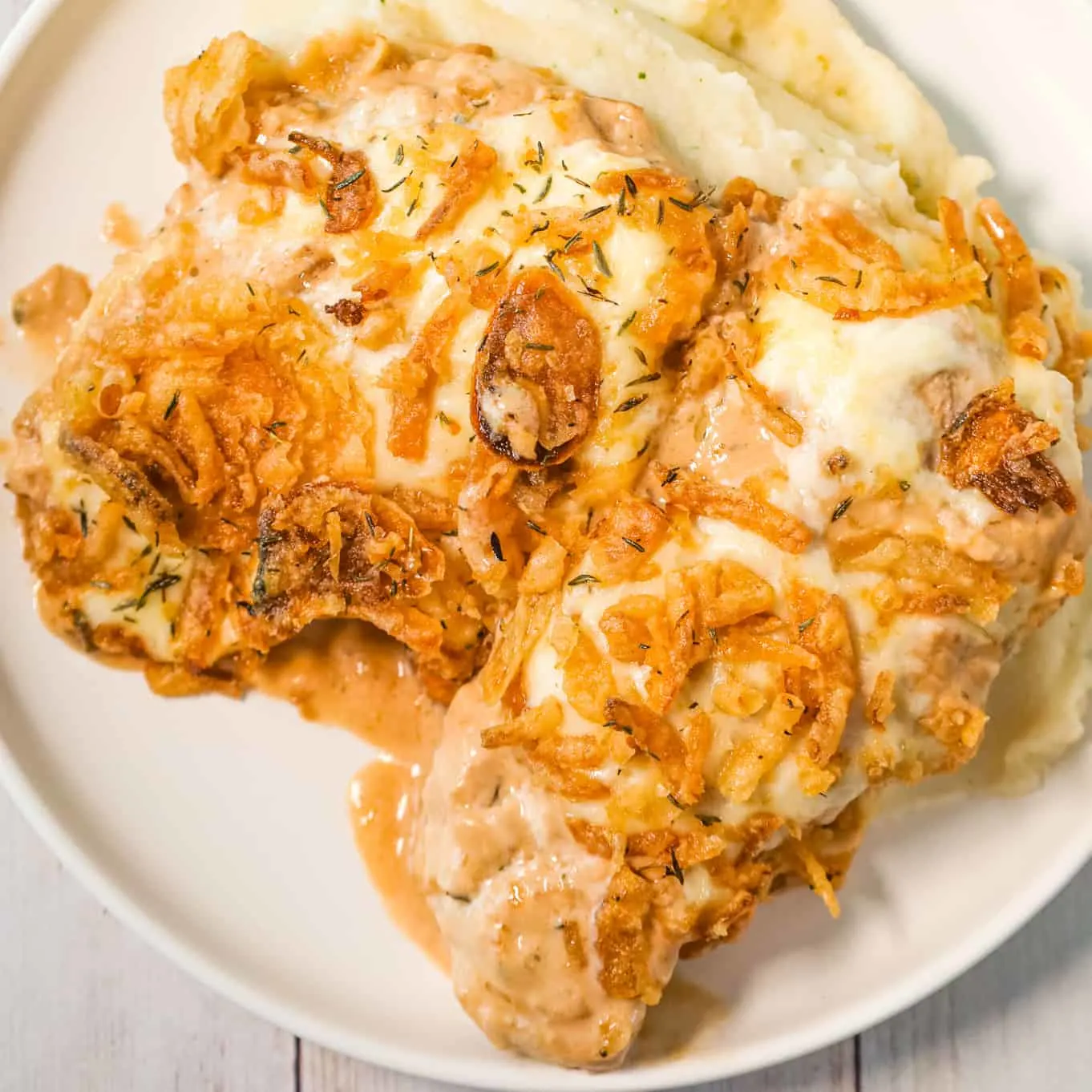 French Onion Pork Chops are an easy baked pork chop recipe loaded with sour cream, onion soup mix, provolone cheese and crispy fried onions.