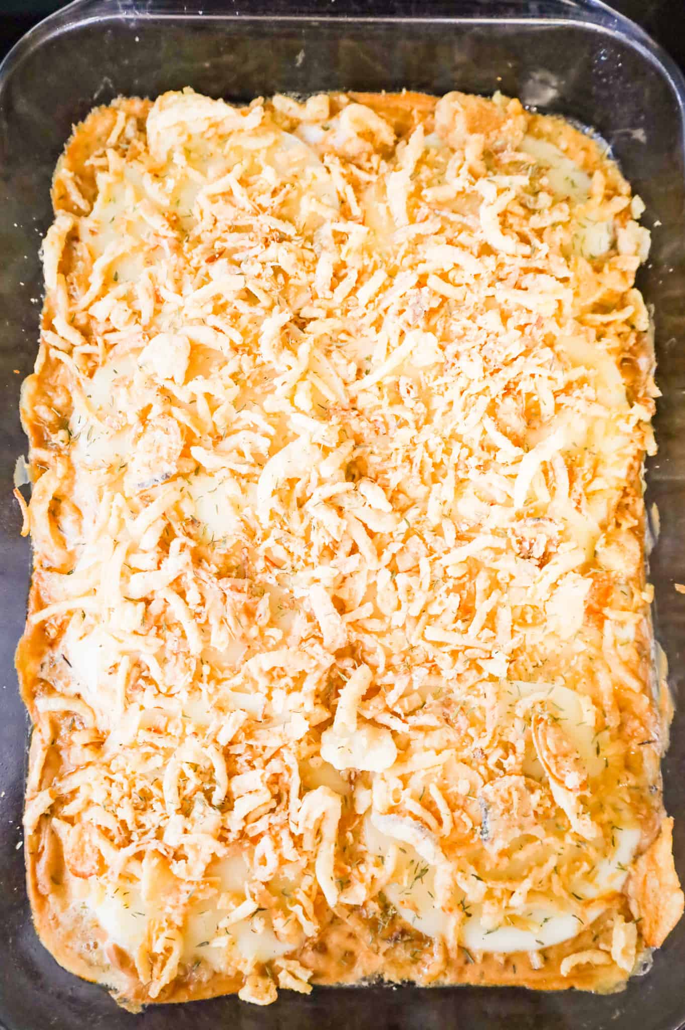 crispy fried onions and cheese on top of pork chops in a baking dish