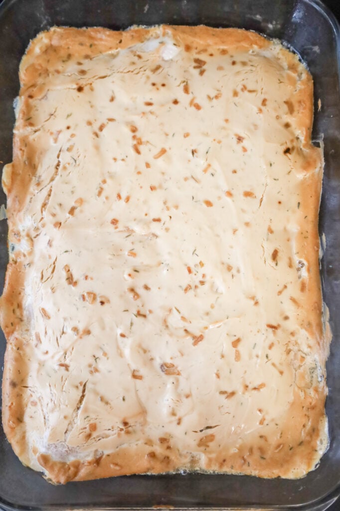 baked sour cream mixture and pork chops in a baking dish