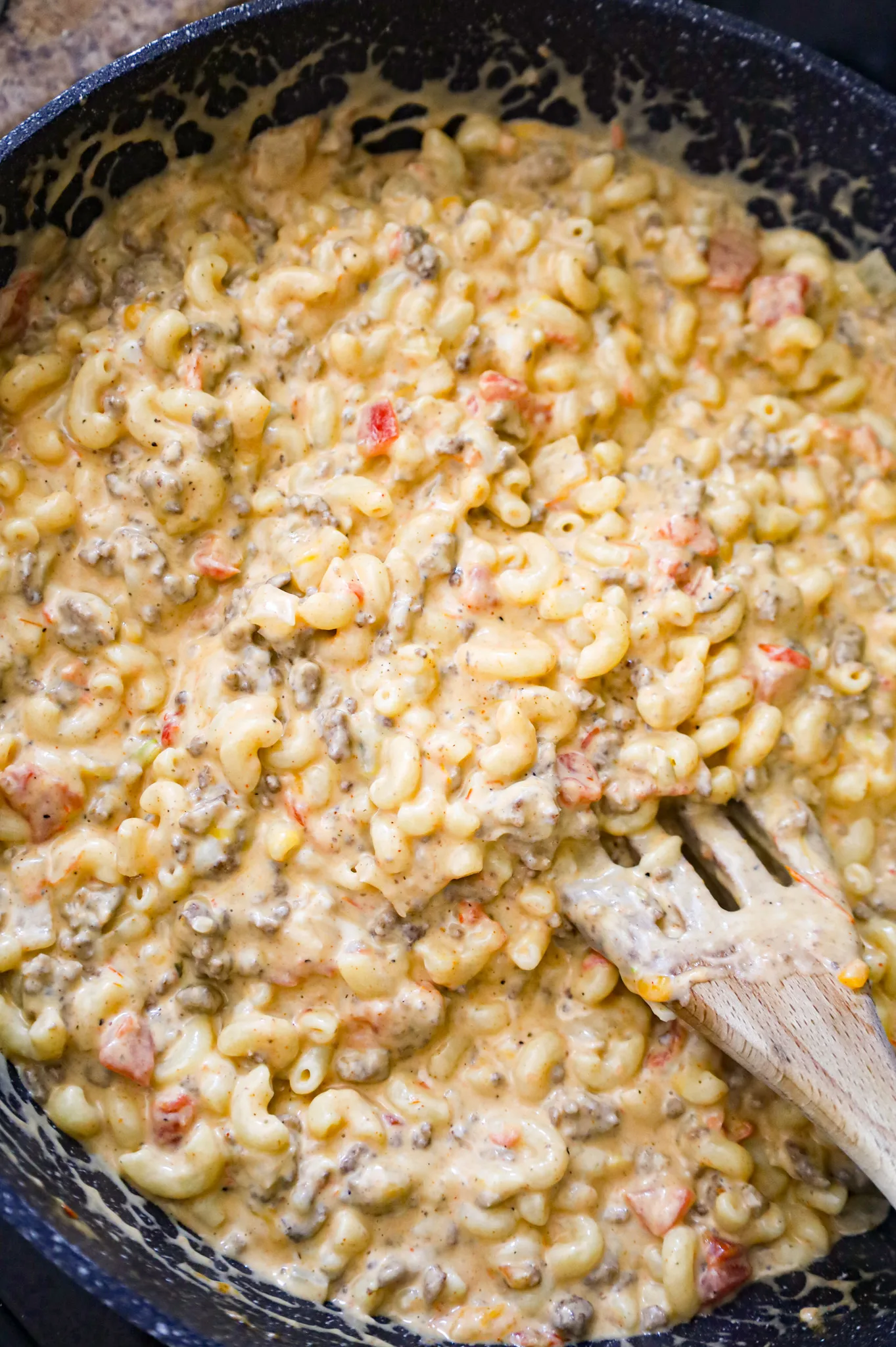 taco mac and cheese being stirred in a skillet