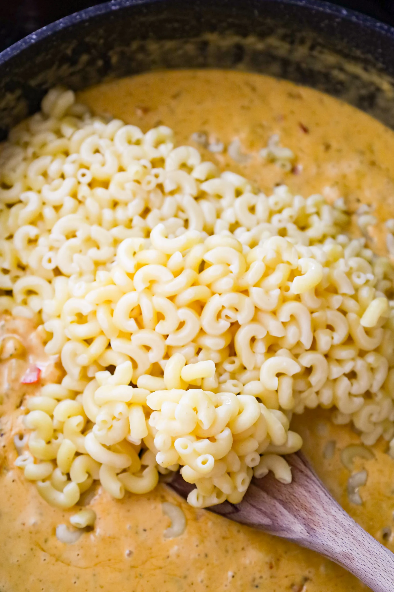 cooked macaroni noodles added to skillet with creamy Cajun sauce