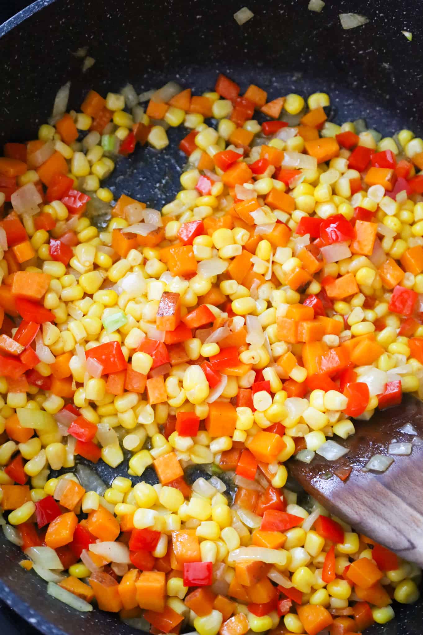 corn, diced peppers, onions and sweet potato in a skillet
